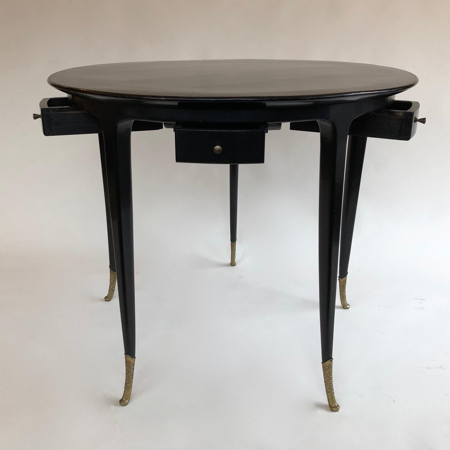 Ebonized 1940s Circular Black Ebonised Italian Games Table with Drawers and Brass Sabots