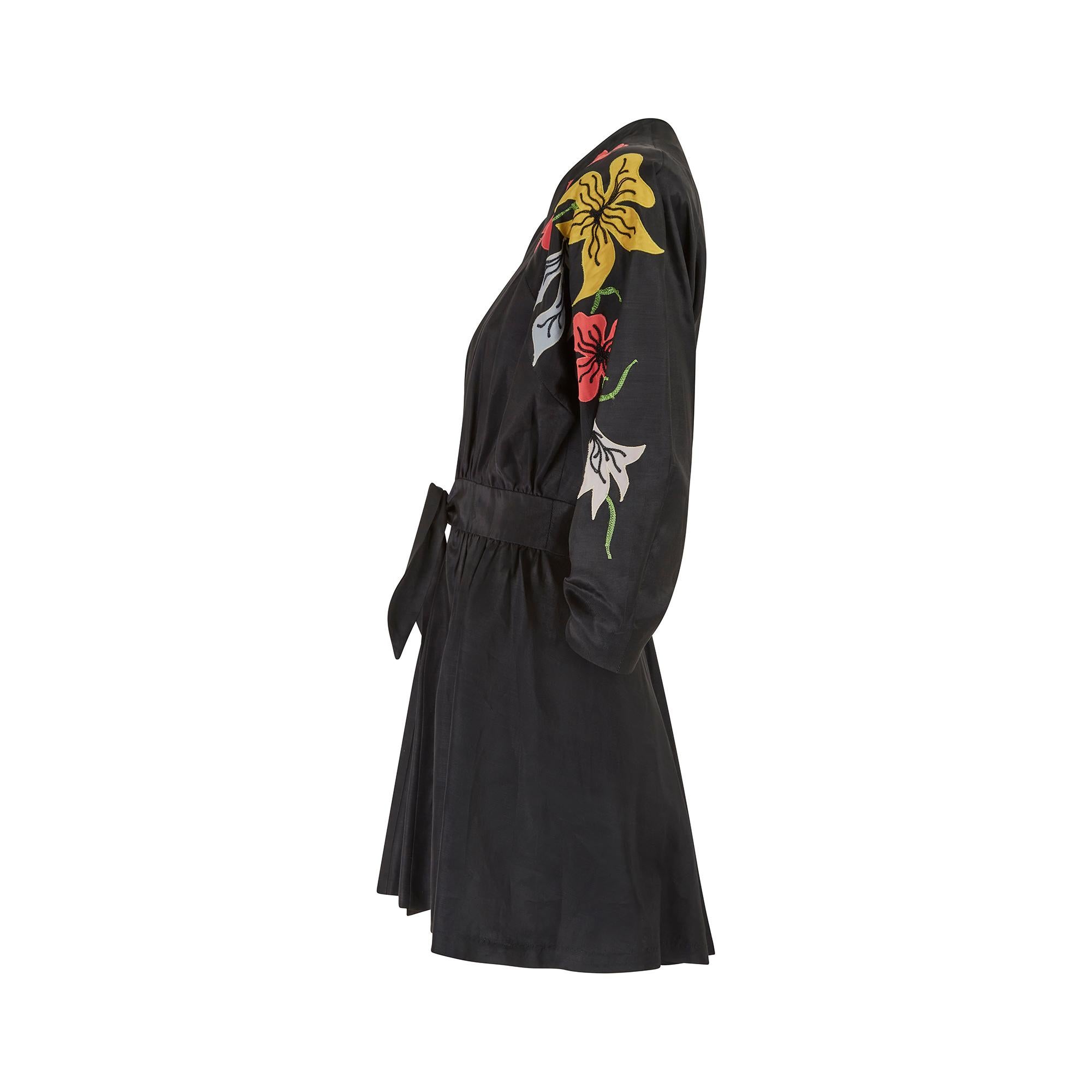 This original late 1940s kimono style jacket is tailored from a rich black, man-made grosgrain fabric which has a lovely texture and sheen. Imbued with a sense of fun, the flared cut swirls around the wearer. The left sleeve is adorned with bold