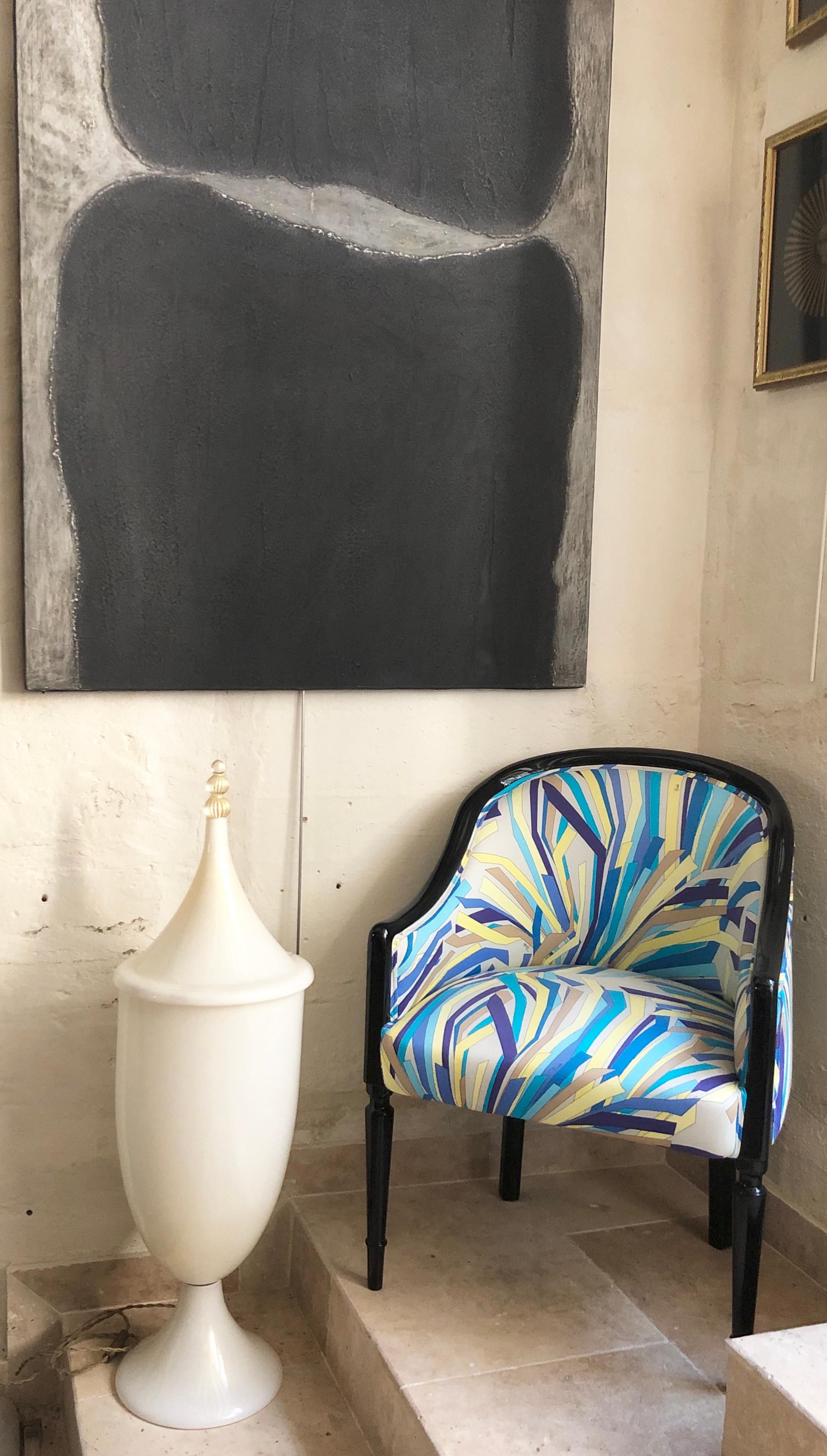 This 1940's vintage tub armchair is dressed in an Emilio Pucci 1970s fabric. Black lacquered legs serve as the perfect contrast to this abstract cool-toned pattern of blue, green, and cream. This original chair was recovered later with Pucci's 1970s
