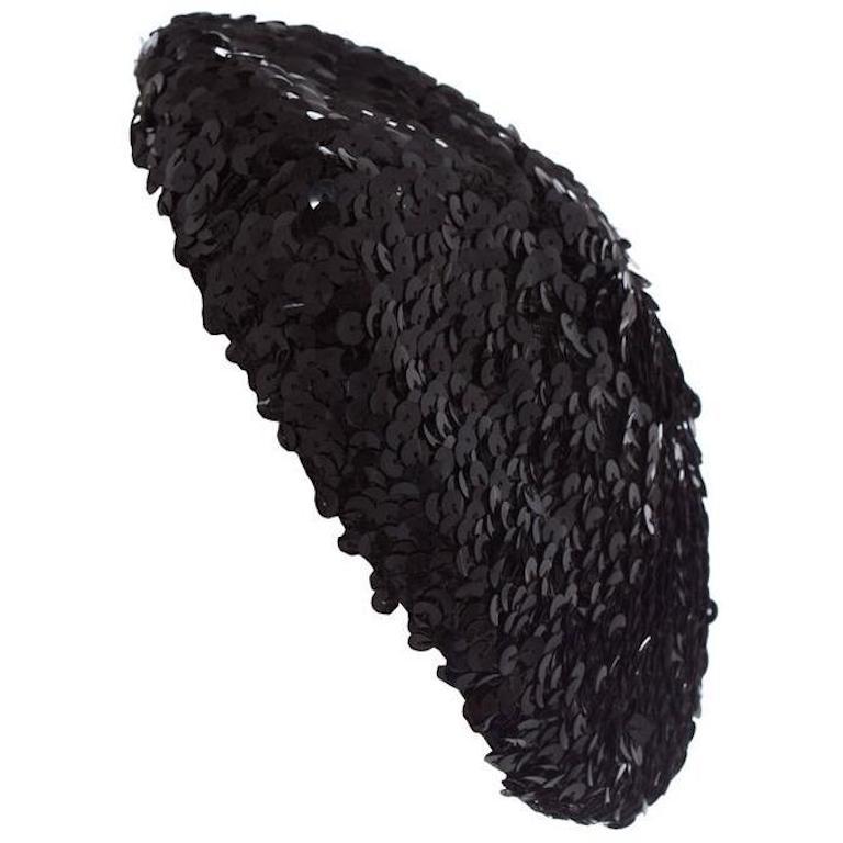 This is an original vintage cocktail hat which is very well made.  It is a black fully sequined beret style and lined in black mesh.  Of a smaller oval shape design, almost fasinator like and very easy to wear in a variety of styles.  Will add a