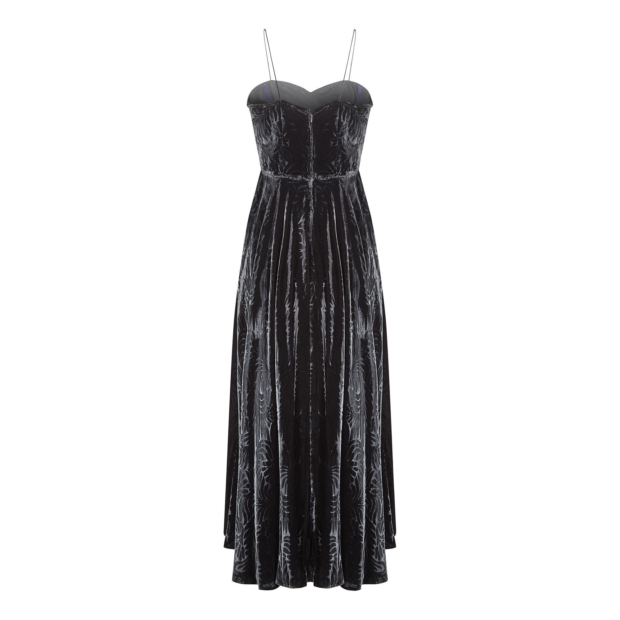 Circa 1940s, this embossed panne silk velvet dress has a fabulous Art Deco floral and leaf print with a full length, panelled skirt.  The full circular hem has bias cut elements which ensure an even flared fit. The bodice is neatly fitted with a