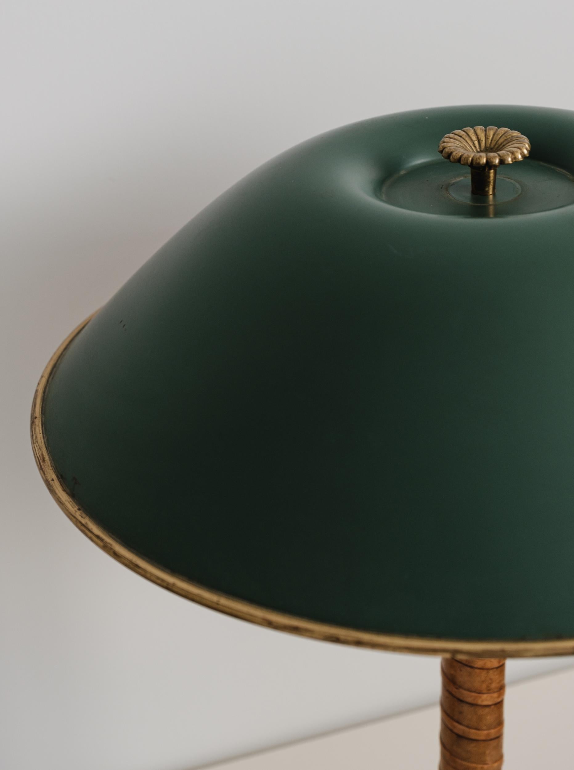 1940s Böhlmarks brass and leather table lamp. Produced by the iconic Swedish lamp maker circa 1940 and executed in green painted metal, brass and beautifully distressed but tight leather wrapping. Reminiscent of the early designs of Paavo Tynell for