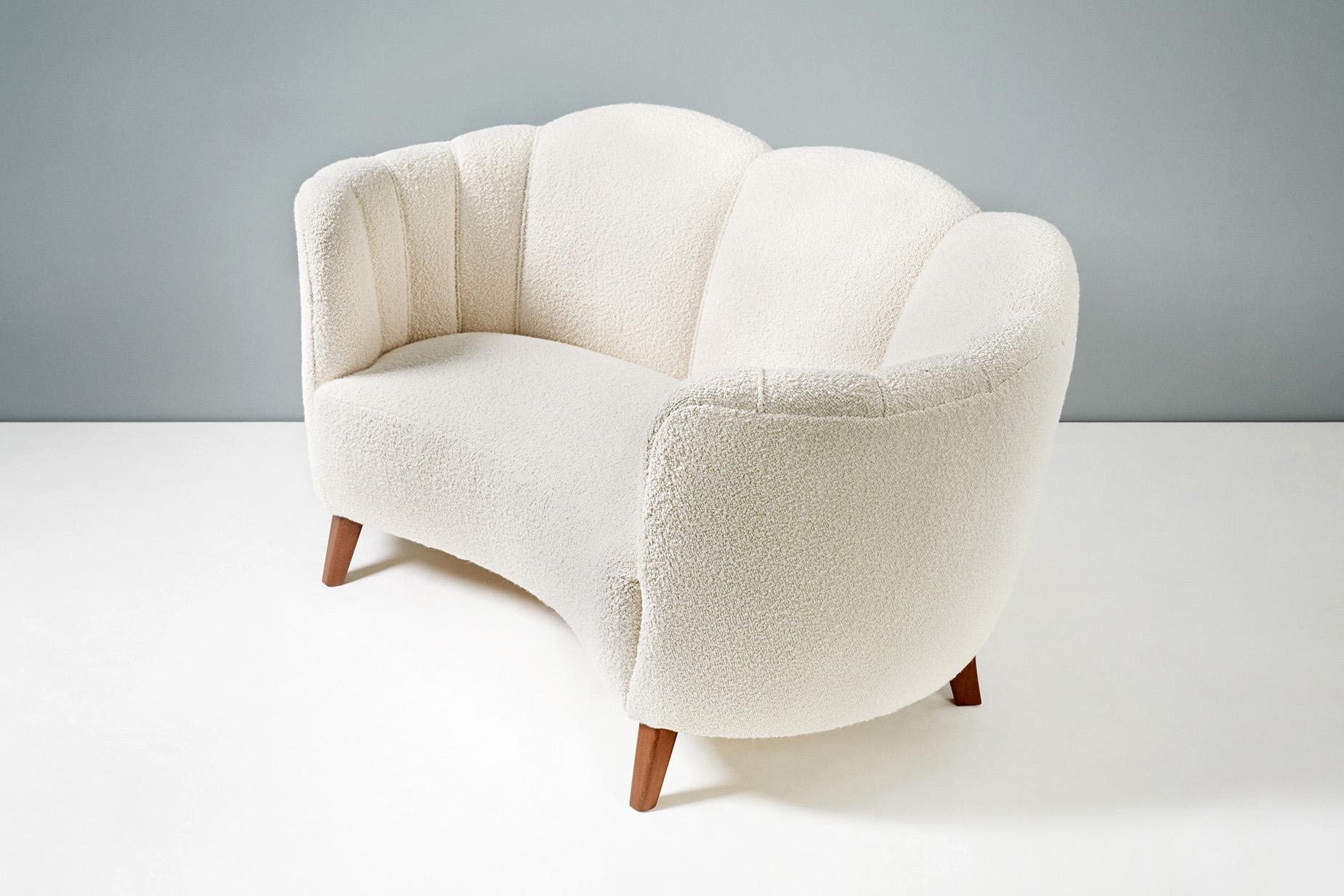 Danish cabinetmaker made loveseat, circa 1940s.

Produced in Denmark in the 1940s with stained beech legs and new bouclé wool fabric. The sofa has been completely reconditioned at our London workshops with new springs, foam and upholstery.
  