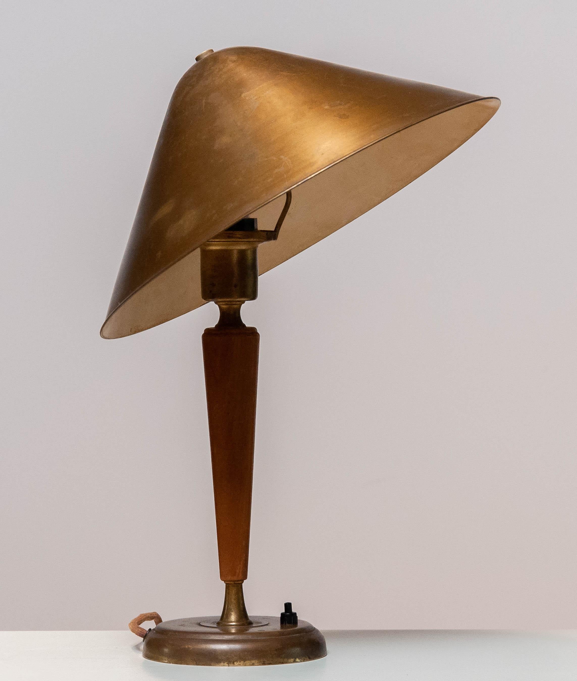 Brass and elm modernist table / desk lamp with beautiful patina true the years by Harald Norton for Böhlmarks in Sweden from the 1940's. 
The shade is adjustable in angle.
Consists one E27 / 28 screw fitting for 110 and 230 volts and in allover good