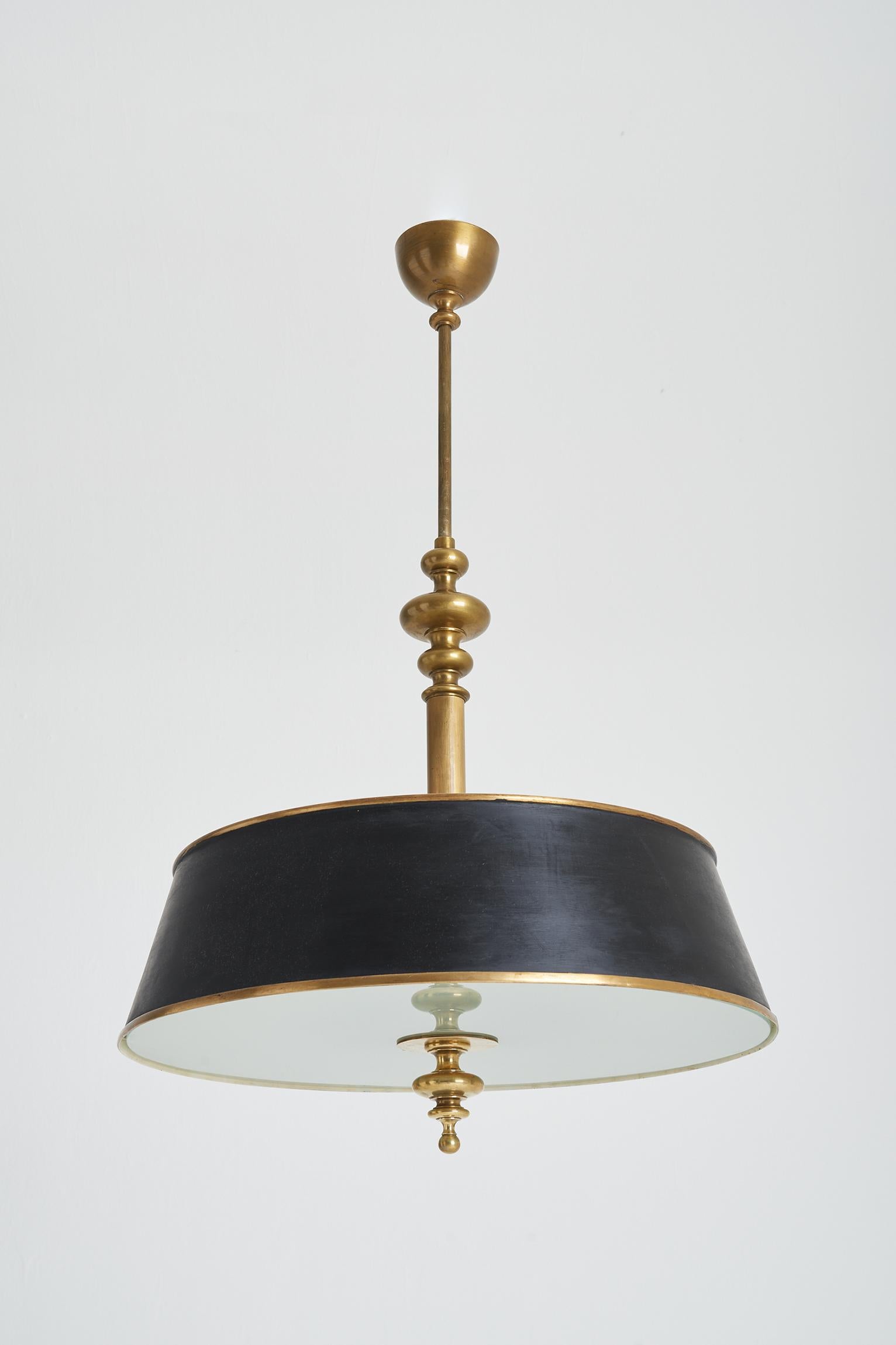 A large brass, sanded glass and black tole ceiling light.
Internally lit with 8 lights, and the recessed top enclosing 4 more.
Sweden, Circa 1940.