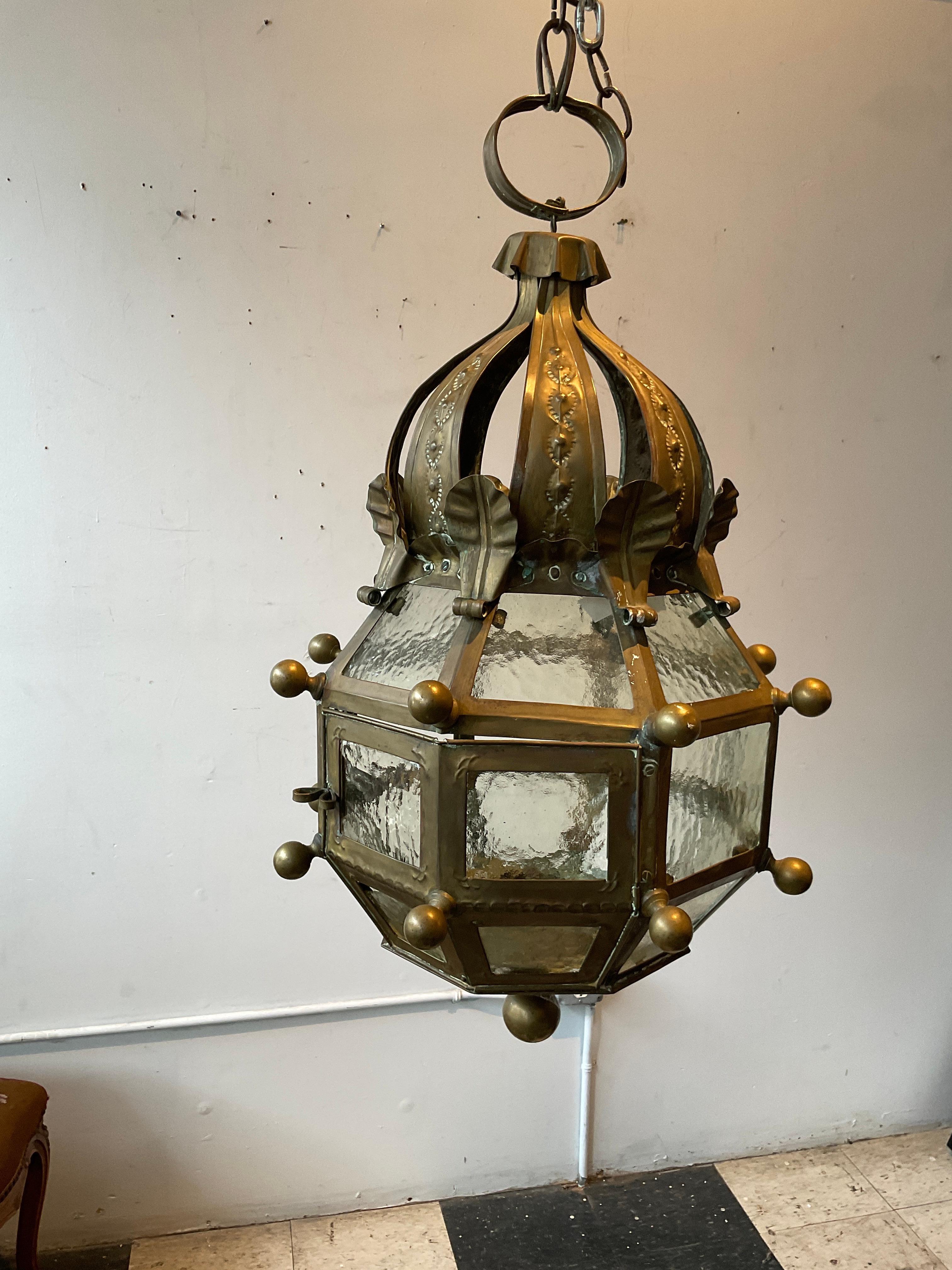 1940s Brass and glass lantern with Vaseline glass. This is meant for a candle, but if brought to an electrician, they can wire it for electricity. Presently only used for candles.
One piece of glass has a piece broken off.
One fastener is missing