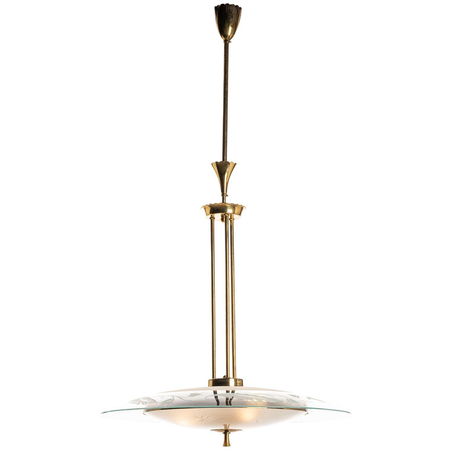 This elegant piece consisting of a brass frame and a unique frosted and satin glass reflector. 
The round curved glass reflectors with its floral and Sun motif mounts between a brass ring and three rods. In the center 3 electrical E14 sockets.
 