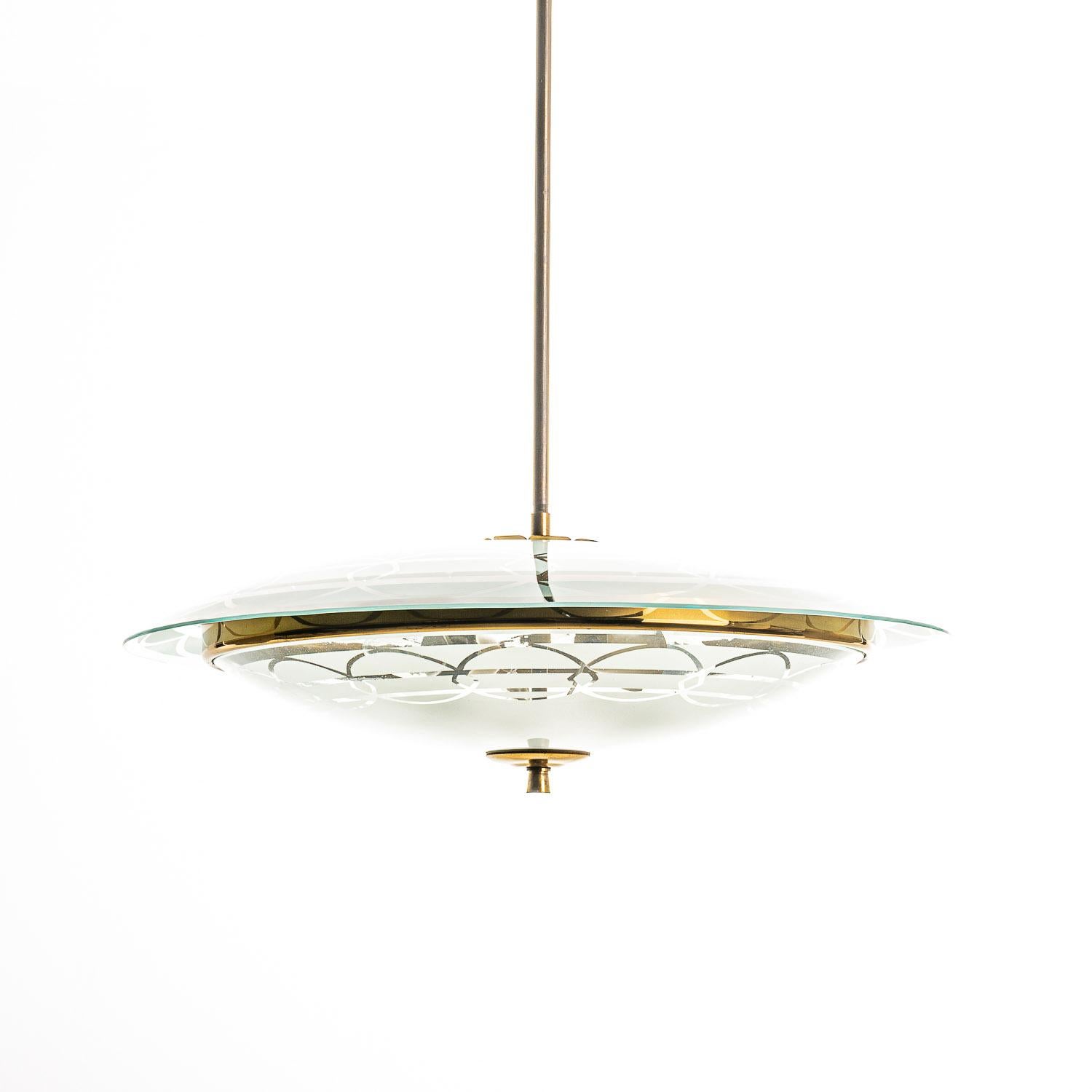 This elegant light consisting of a brass frame and 2 unique glass reflector/saucers. 
The lower round curved glass reflector with mounts below a larger round etched & clear glass reflector. A beautiful decorated brass ring to connect the panels. In