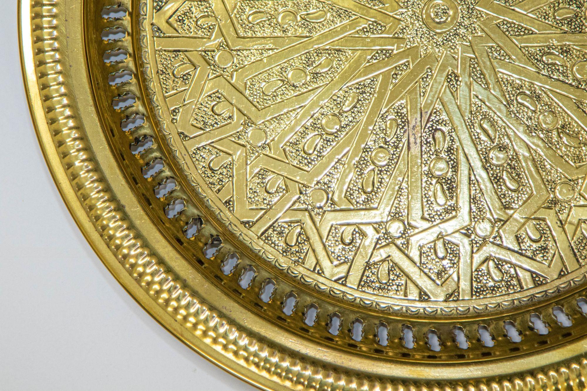The hand-hammered brass Moroccan tray with fine intricate Islamic design is a stunning piece of craftsmanship that exudes the beauty and intricacy of Moroccan artistry. This exquisite tray showcases the rich cultural heritage and traditional