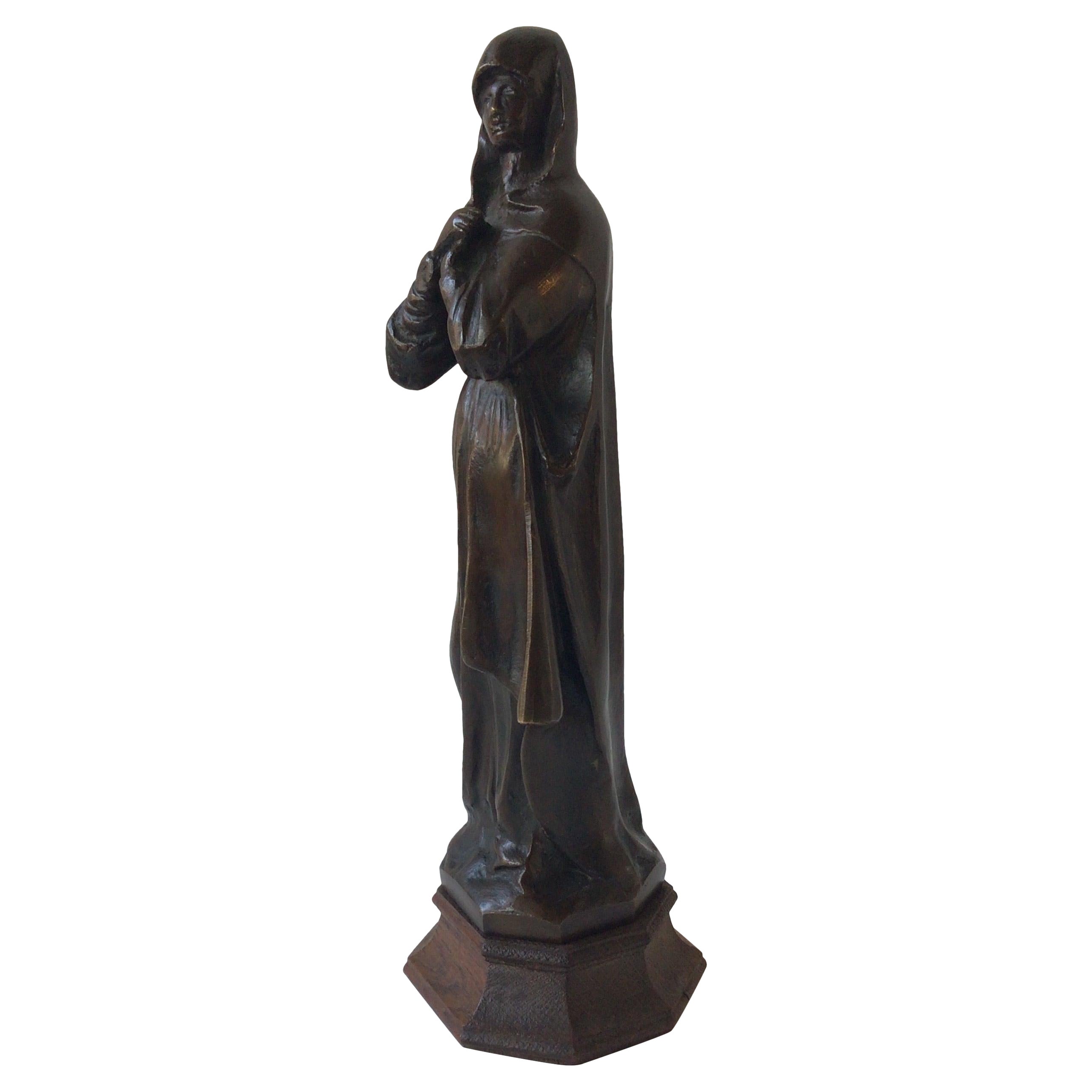 Escultura de bronce de una monja de los años 40