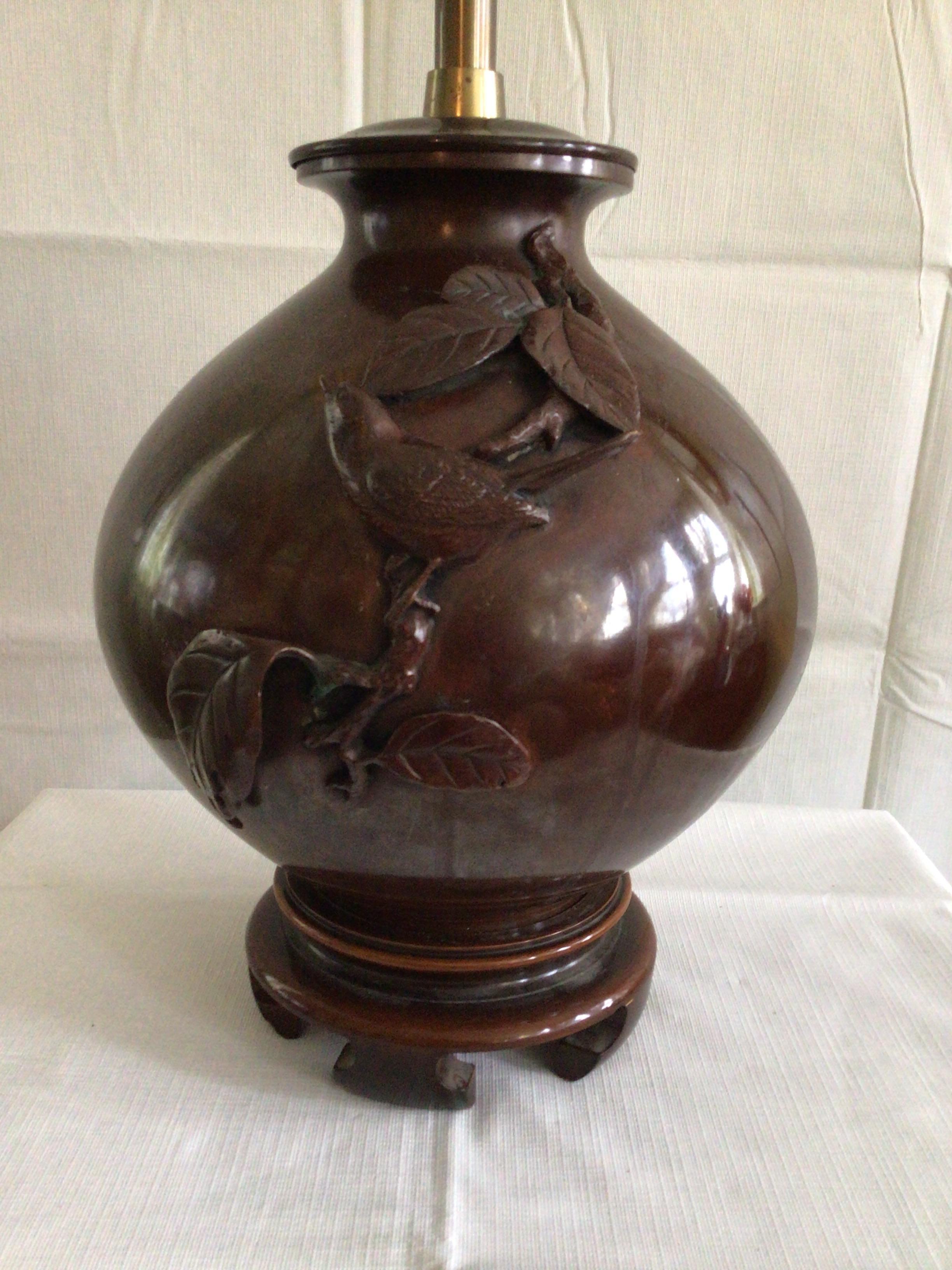 1940s bronze table lamp with bird on Asian style wood base.