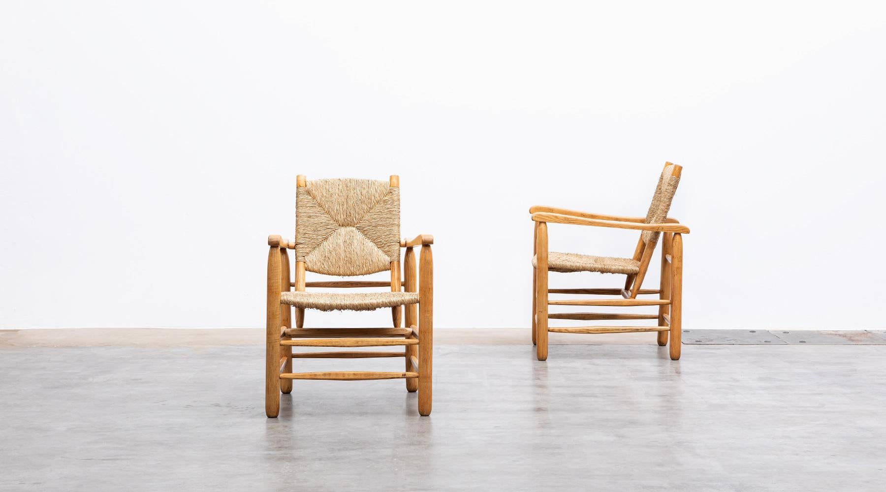 Mid-Century Modern 1940s Brown Oak and Rush Pair of Lounge Chairs by Charlotte Perriand