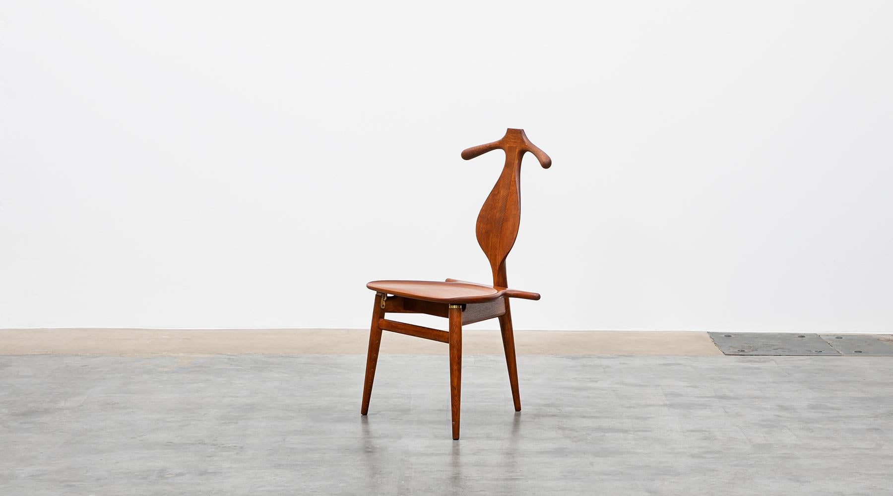 Valet chair, oak, teak, brass details, by Hans Wegner, Denmark, 1953.

A wonderful example of a masterpiece by the famous Hans Wegner. A practical Valet chair that is completely organically shaped. The seat can be folded up so that it can also be