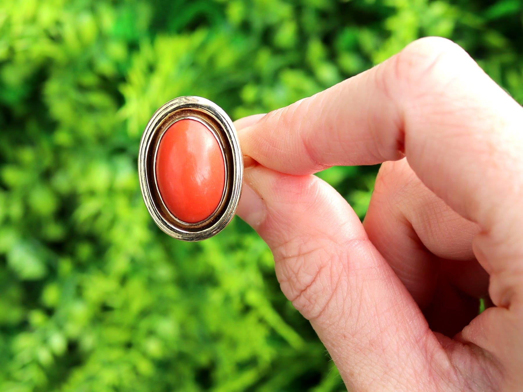 A fine and impressive 14 karat yellow gold vintage coral cocktail ring; part of our diverse vintage jewelry and estate jewelry collections.

This fine and impressive vintage cabochon cut coral ring has been crafted in 14k yellow gold.

The ring