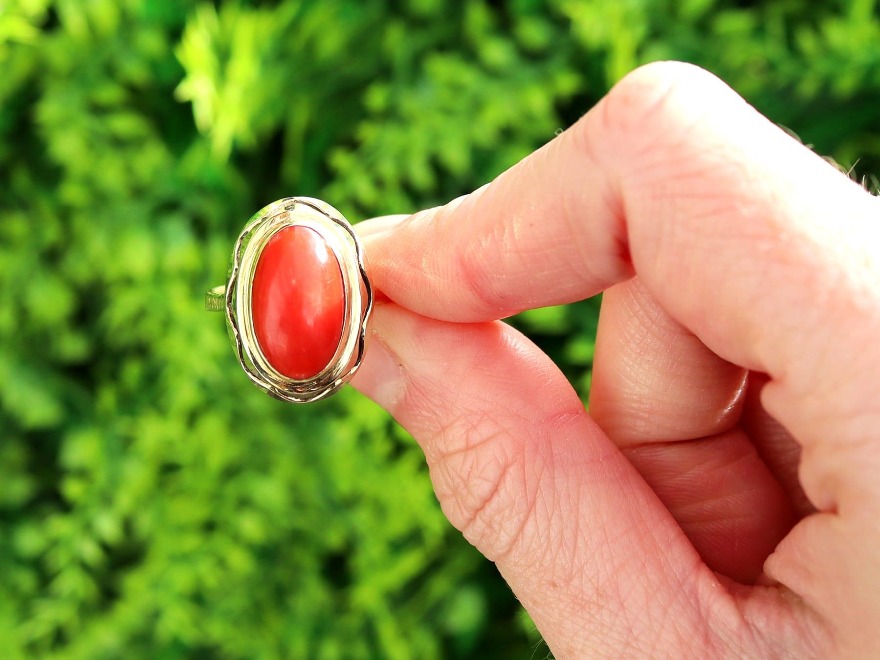 A fine and impressive vintage natural coral and 14 karat yellow gold cocktail ring; part of our vintage jewelry and estate jewelry collections.

This fine and impressive vintage cabochon cut coral ring has been crafted in 14k yellow gold.

The