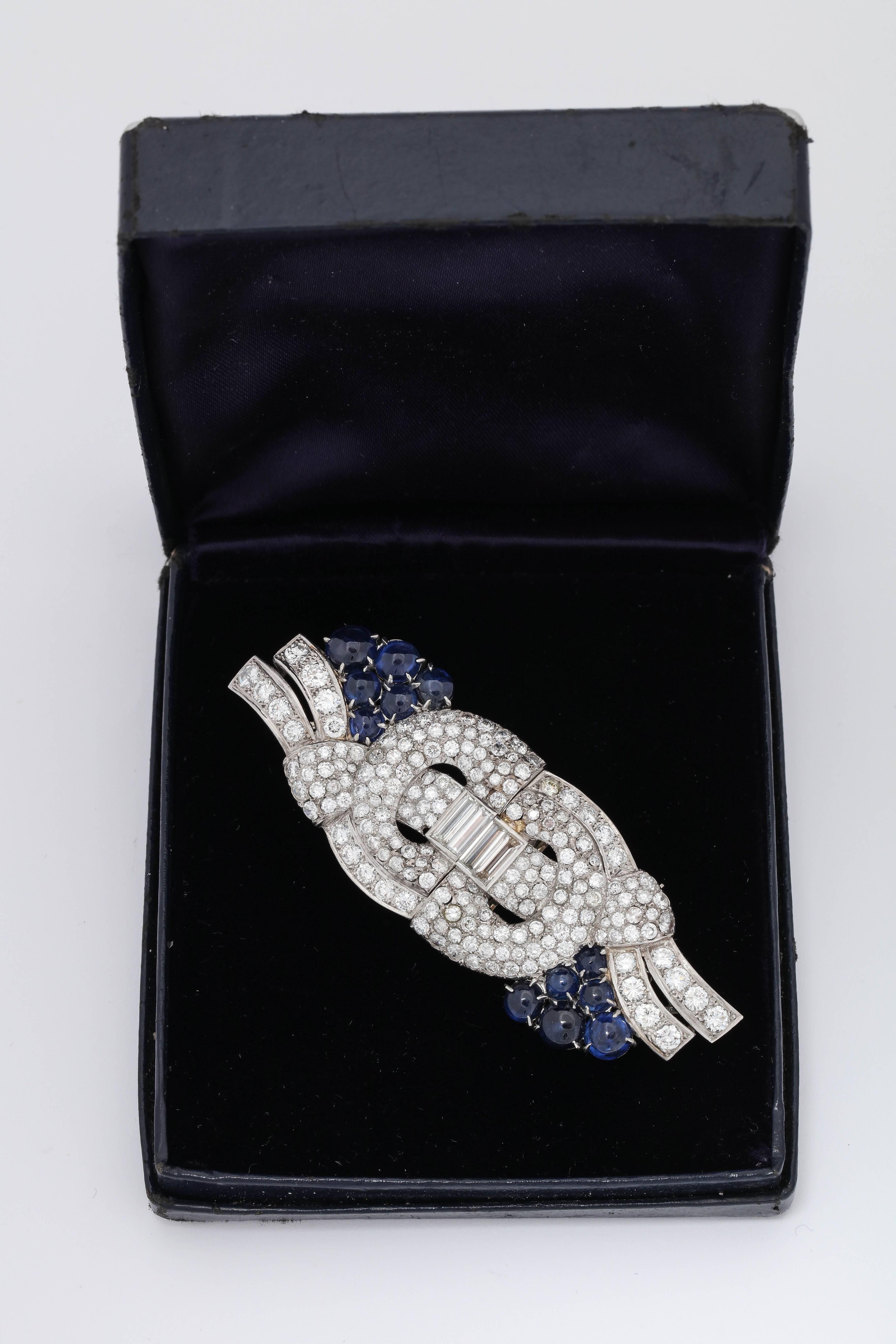 One Ladies  Three Dimensional Platinum Convertible Brooch Embellished With {12} Cabochon Beautiful Color Sapphires Weighing Approximately {5} Carats Total weight.Brooch Further Embellished With Numerous Round Cut Diamonds Weighing Approximately {11}