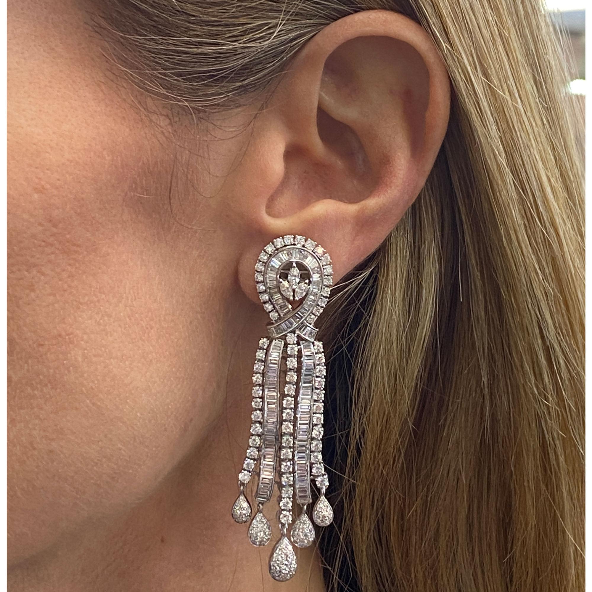 Incredibly elegant diamond chandelier earrings circa 1940-1950's. These long drop earrings feature approximately 10.0 carat total weight diamonds. The diamonds are marquise, round brilliant, and baguette cut diamonds all graded G-H color and VS