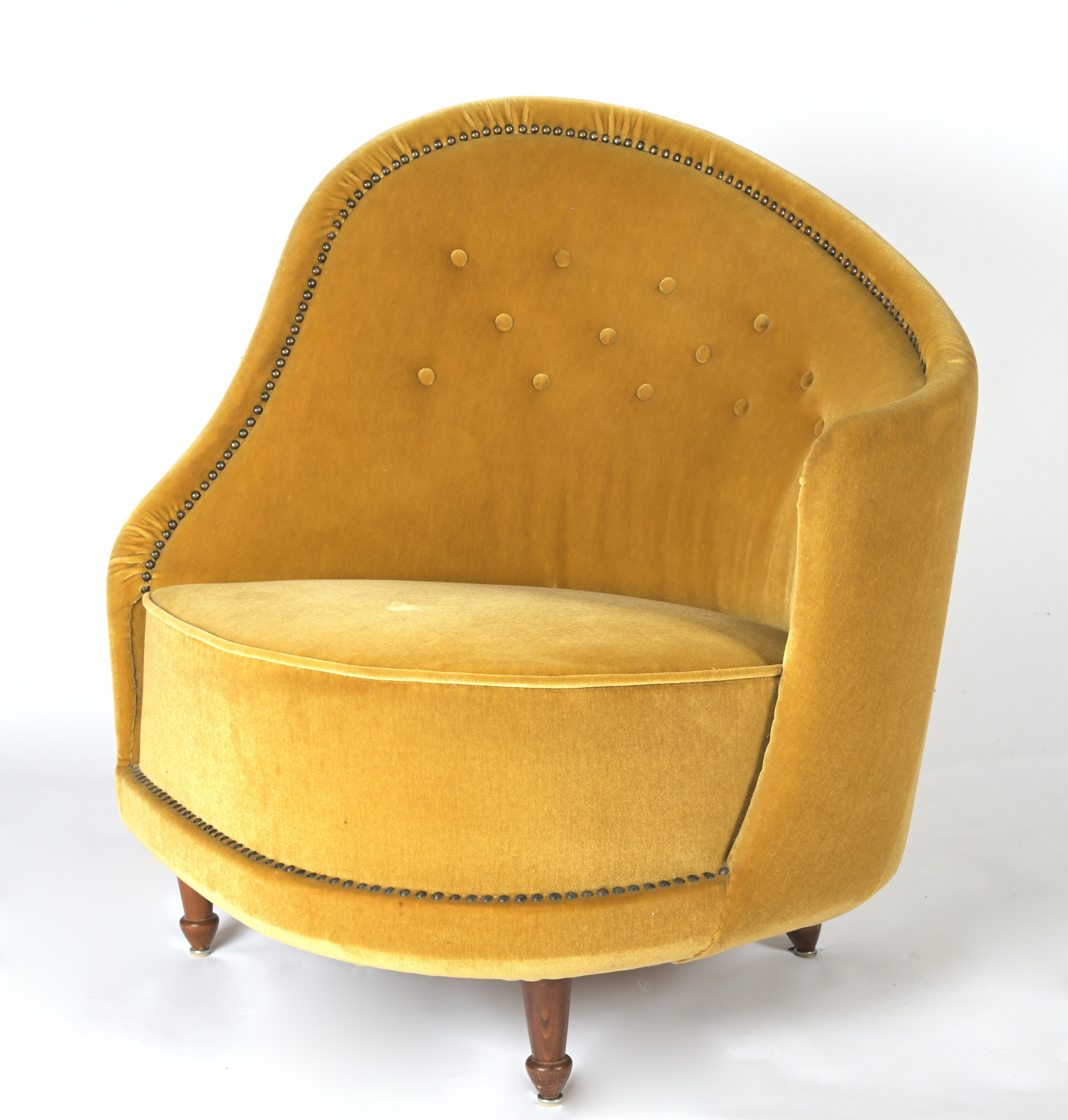 A curved armchair by Swedish Designer Carl Cederholm (1909-) having fabric buttons and tapered teak legs, circa 1940s.