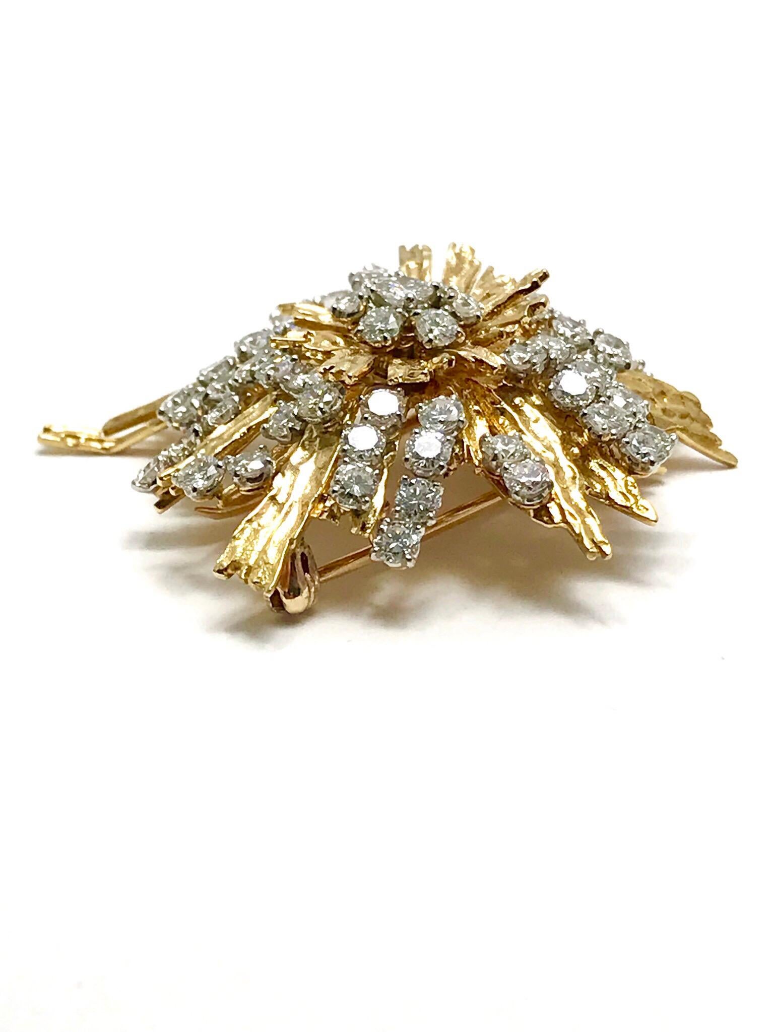 A stunning Cartier Paris Diamond Spray Brooch.  Emulating a firework exploding in the sky, the Diamonds are scattered about from the center in the 18 karat yellow textured gold.  The 61 round brilliant Diamonds have a total weight of 5.00 carats. 