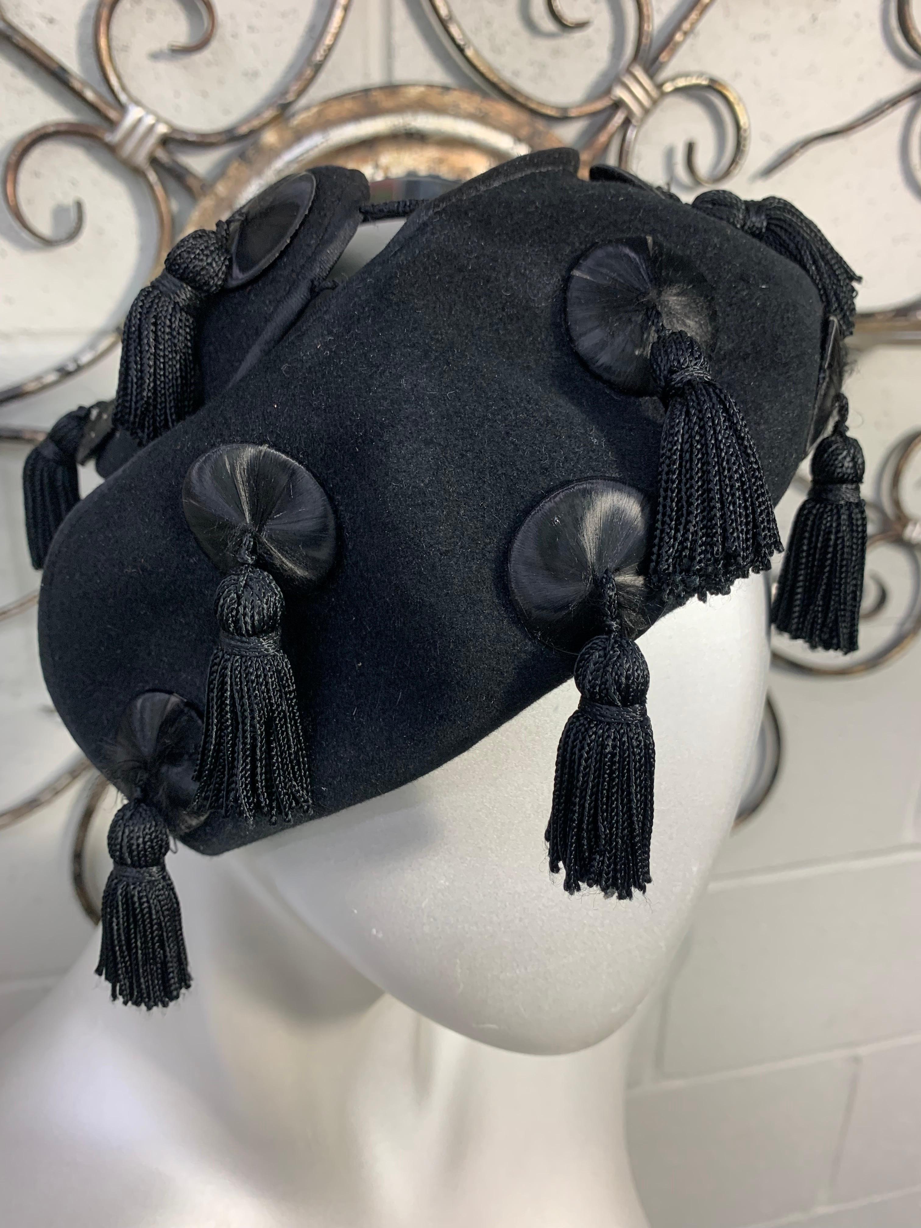A fabulous 1940s Caspar-Davis black wool open-crown hat with all-over silk-flossed buttons and tassels providing captivating movement at every turn and gesture. Size Medium. 