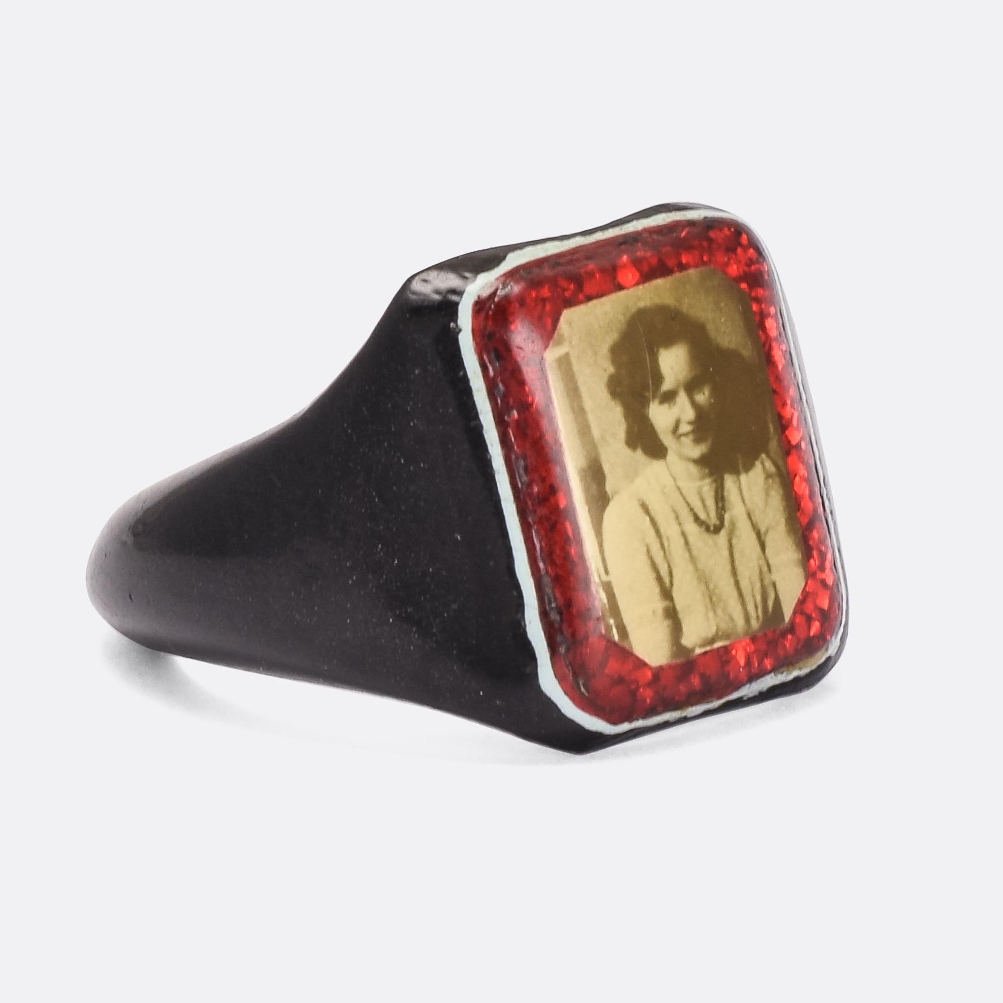A 1940s Prison Ring crafted from celluloid and set on the face with a portrait photograph. These ring would have been made from whatever everyday items were available, toothbrushes or pens etc, and celluloid was preferred as it could be heat bonded