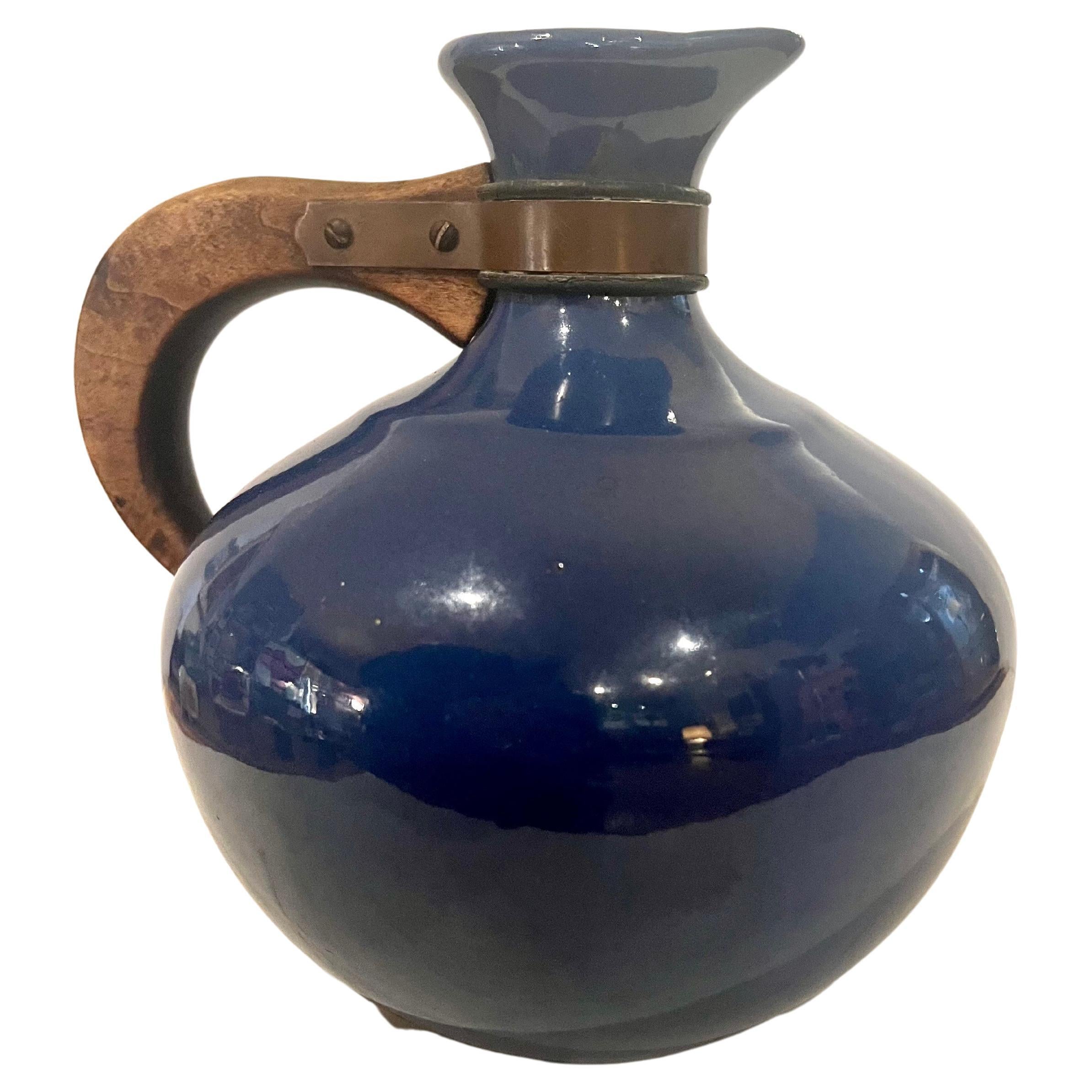 Classic Red Wing carafe , in excellent original condition, circa 1940's good handle with copper fittings no chips or cracks , beautiful cobalt blue glaze.