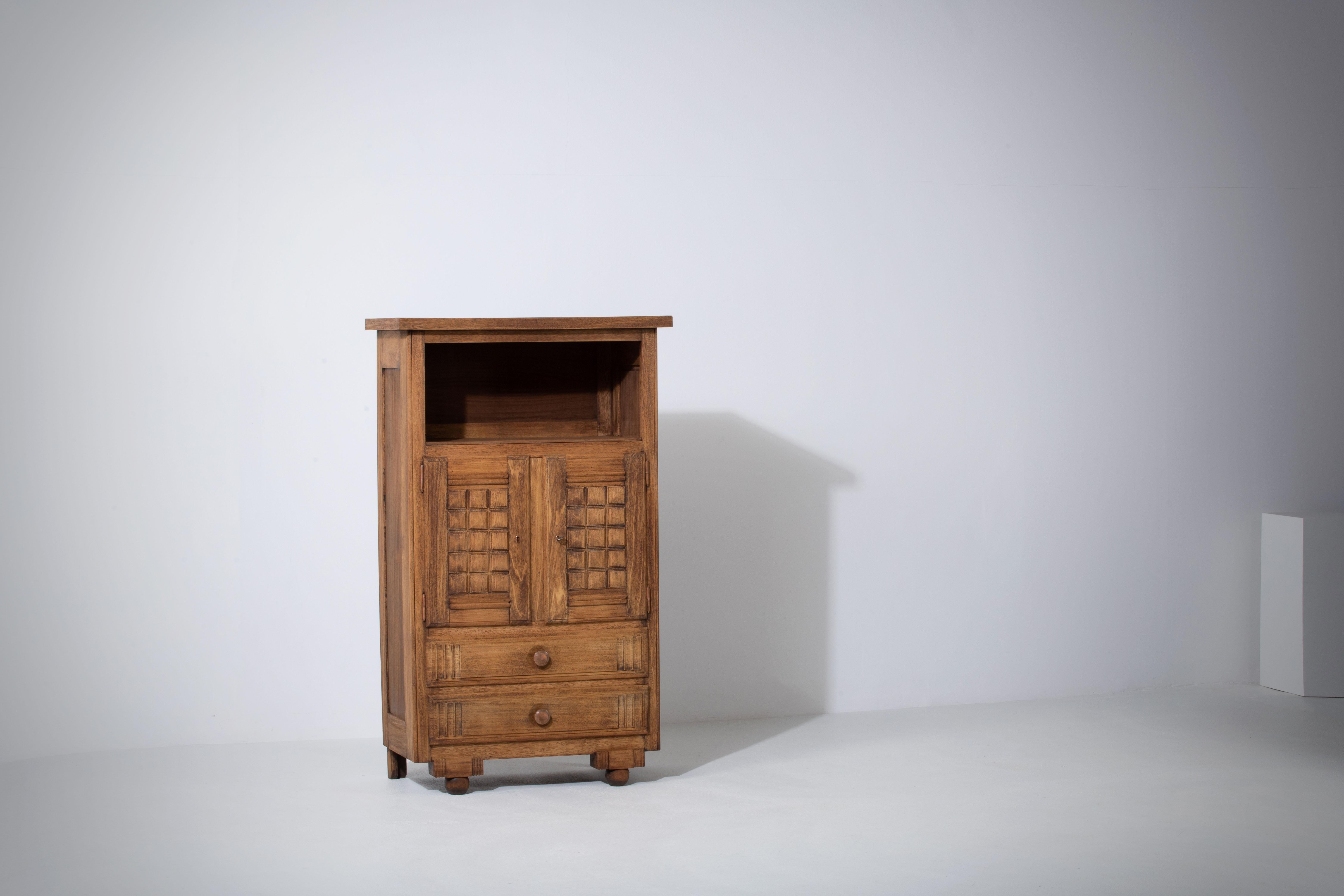 Introducing an extraordinary one-of-a-kind oak cabinet designed by the renowned French designer Charles Dudouyt in the 1940s. Charles Dudouyt was a prominent furniture designer in the early to mid-20th century, known for his remarkable