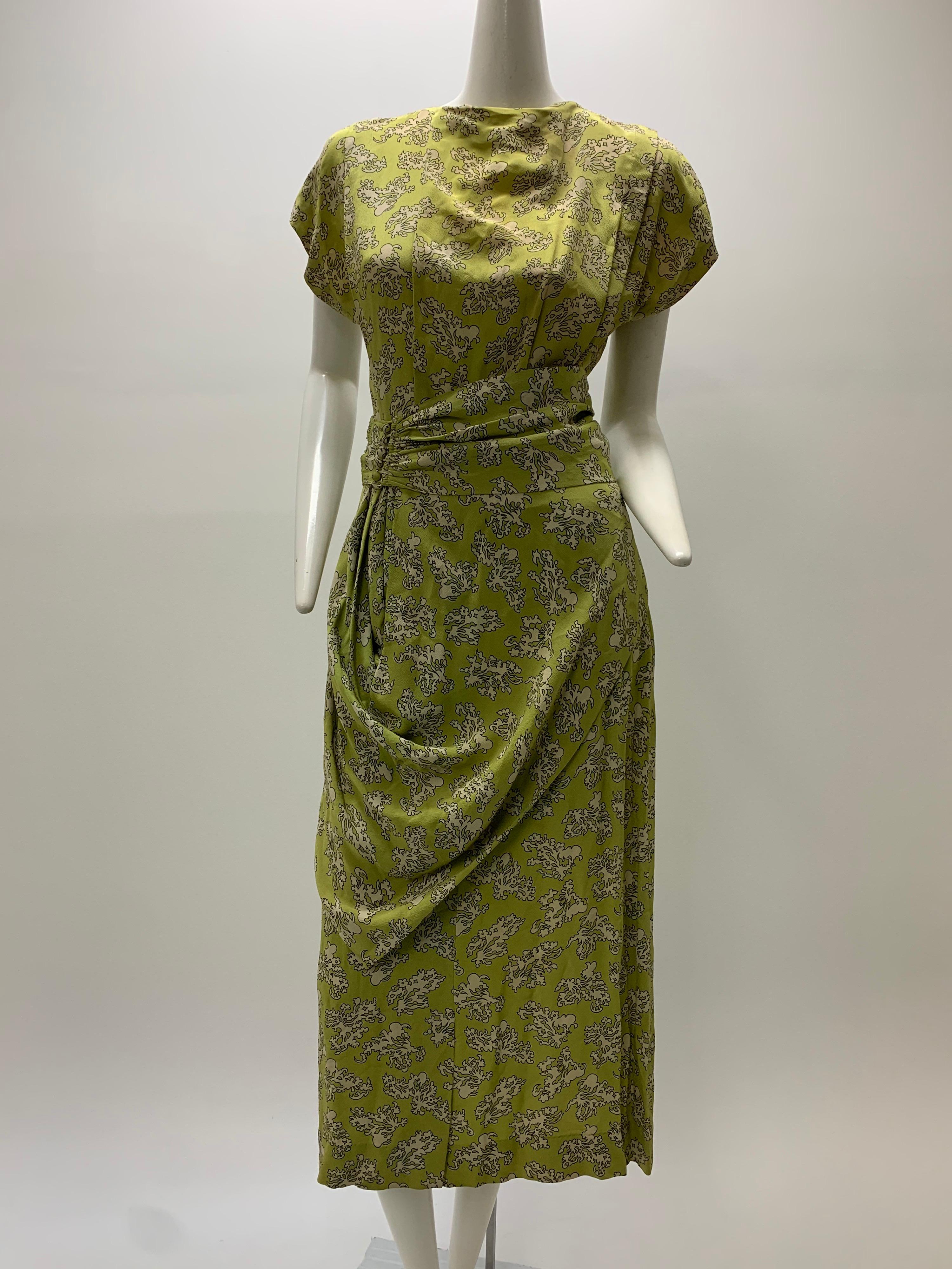 A beautiful 1940s Marian McCoy chartreuse and cream abstract print coral/floral rayon crepe dress with draped hip detail, separate cummerbund belted waist, short sleeved drop shoulders and a keyhole back closure. Mid-calf length. 