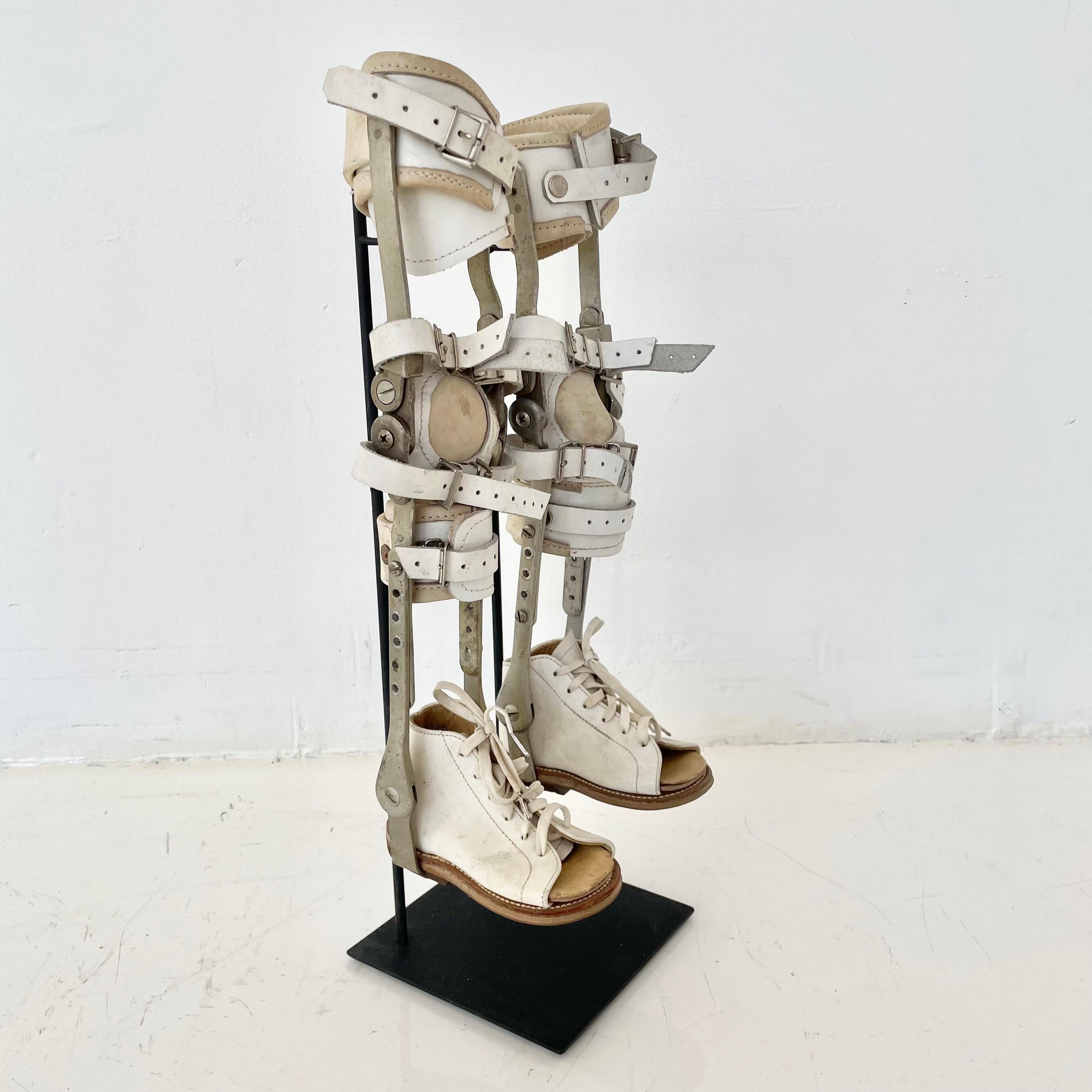 Made in the 1940s, these vintage children's leg braces are an interesting piece of medical history. The leg brace is made from chrome plated steel braces and orthopedic leather. All leather straps and buckles are in good working condition. Large