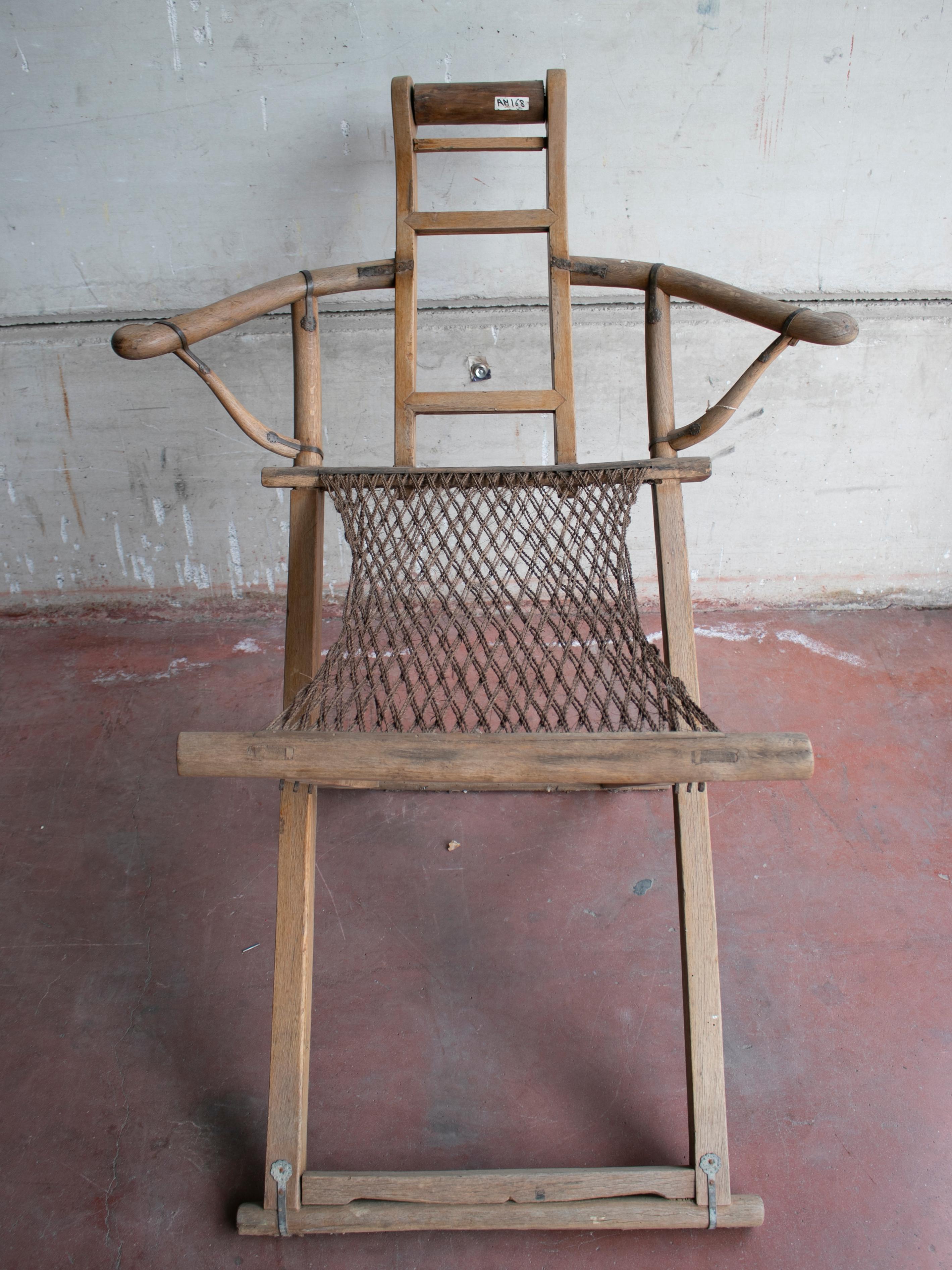 1950s Chinese deck sofa chair with arms and woven string seat.