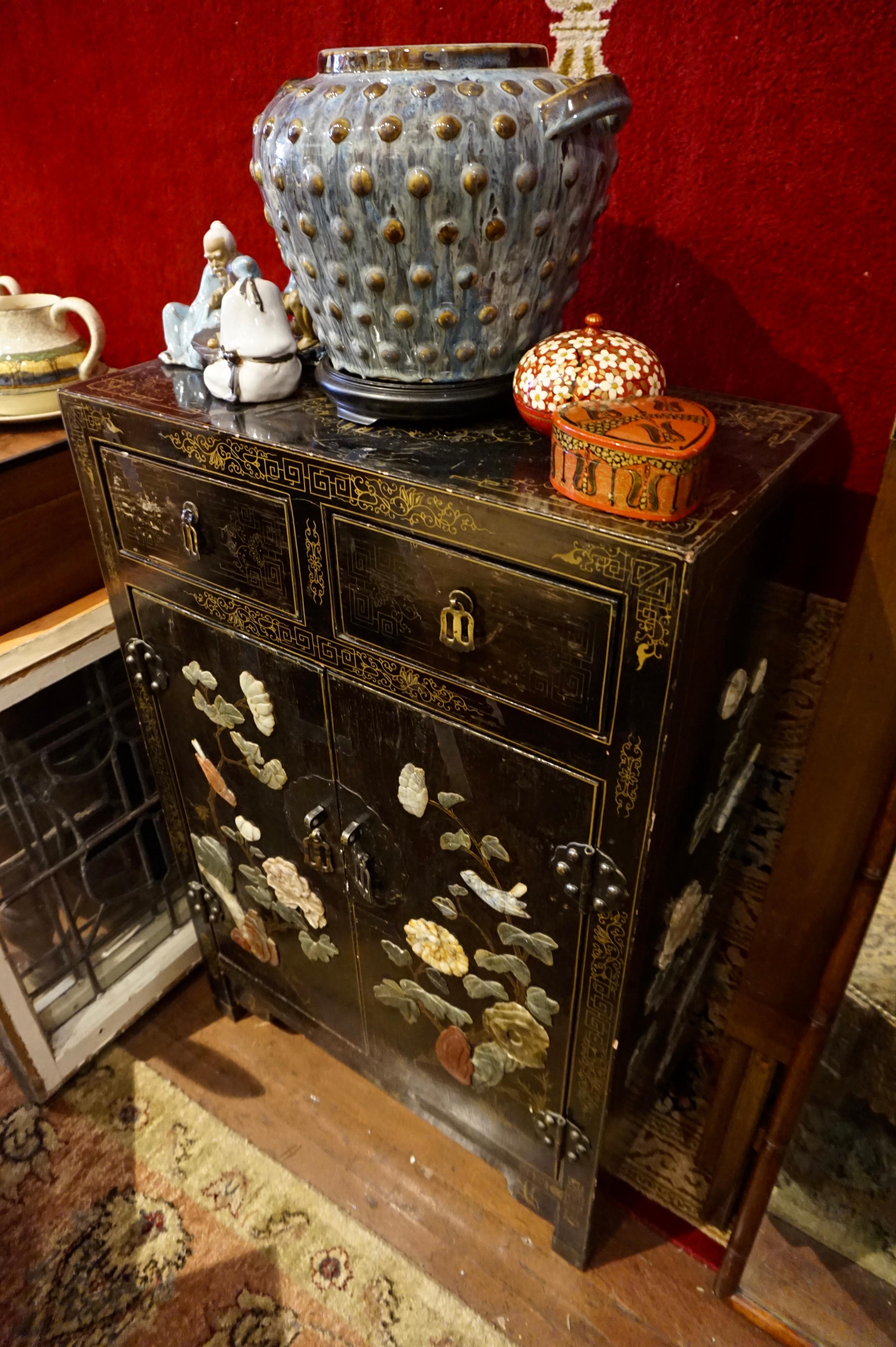 Compact, decorative Chinese export cabinet circa 1940's. Fine gilt work on black lacquer with soapstone carvings of birds in spring. This piece came out of the Estate of a Chinese diplomat and was hastily taped before being shipped overseas years