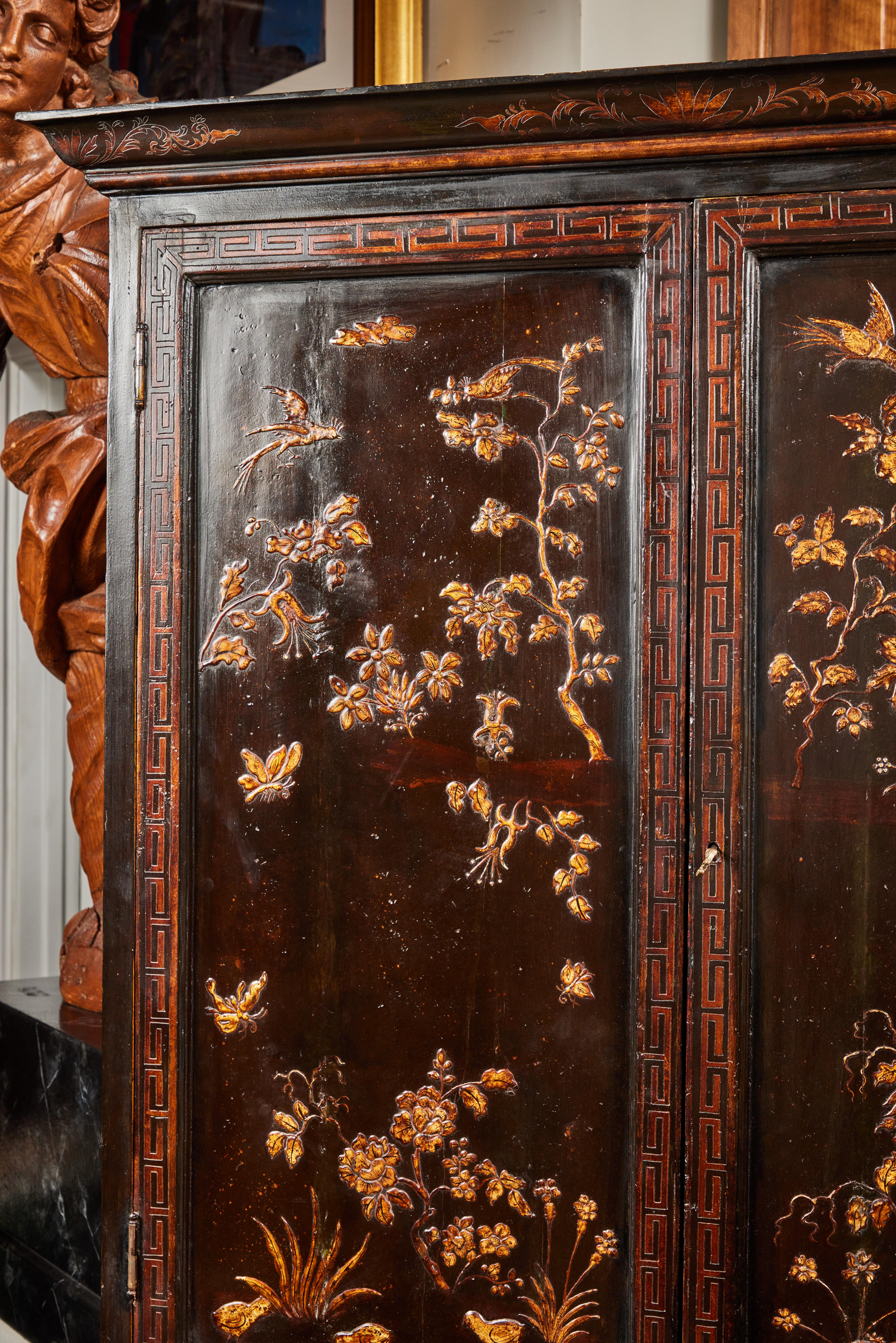 A petite, two part, hand-painted, lacquered, fully finished, drop front Chinoiserie bureau secrétaire from Spain. The interior of the two-door top is wallpapered in faux bamboo fretwork, fitted with arched, hand-painted niches.