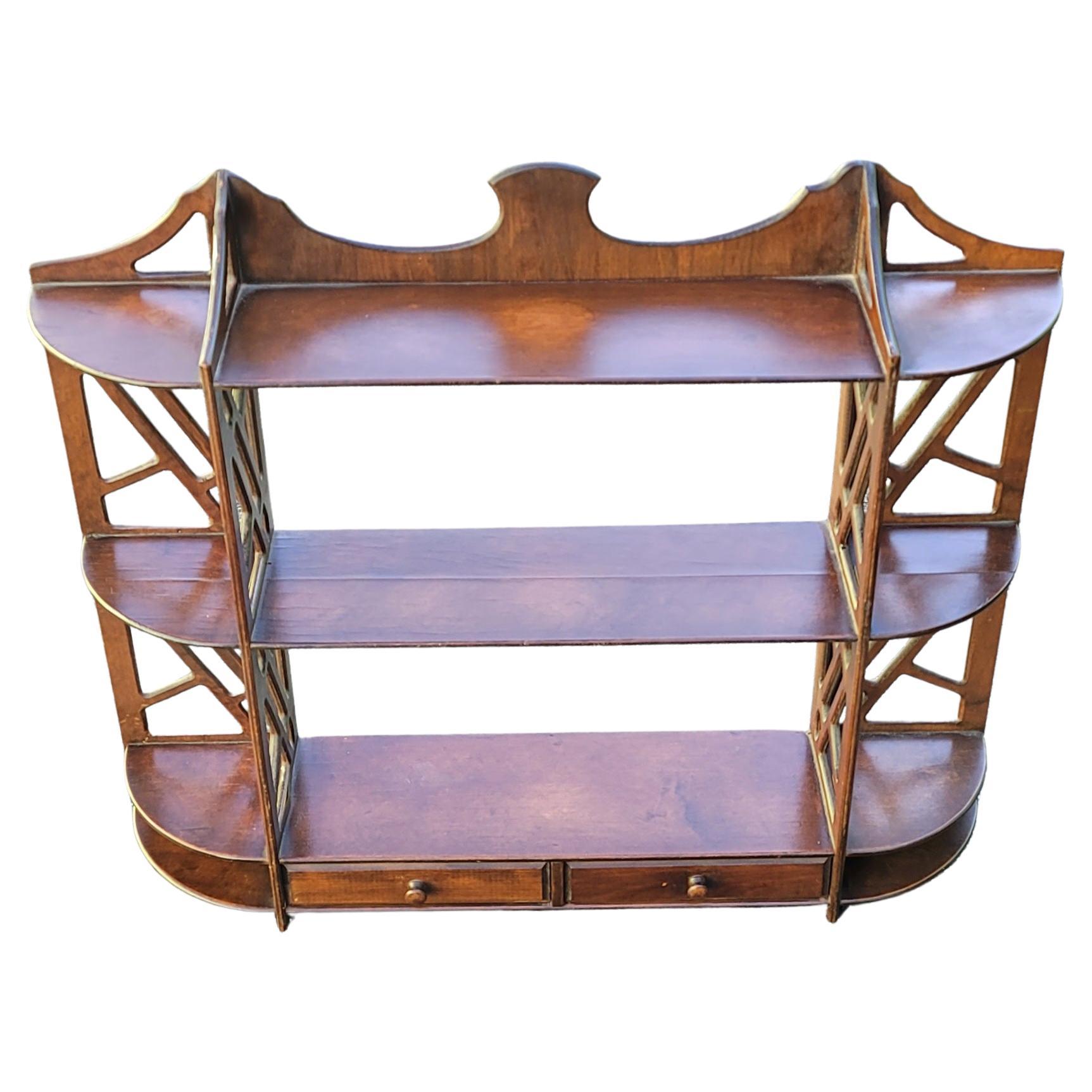 1940's Chippendale style hanging wall shelf with three drawers. Grooves on shelves to display plates or other flat objects. Old school craftsmanship for sure. Store small items in the drawers. Hangs on wall with two screws. Has had several well done