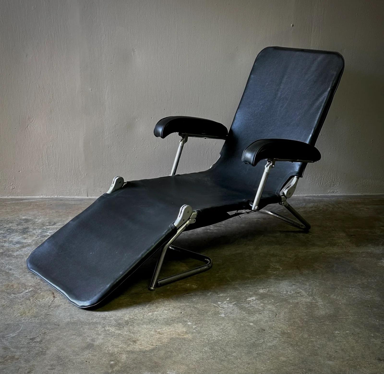 This chrome and black leather adjustable lounge chair from the US captures the essence of industrial design with its sleek, exposed chrome tube framework. The chair's black leather upholstery is both luxurious and durable, offering a comfortable and