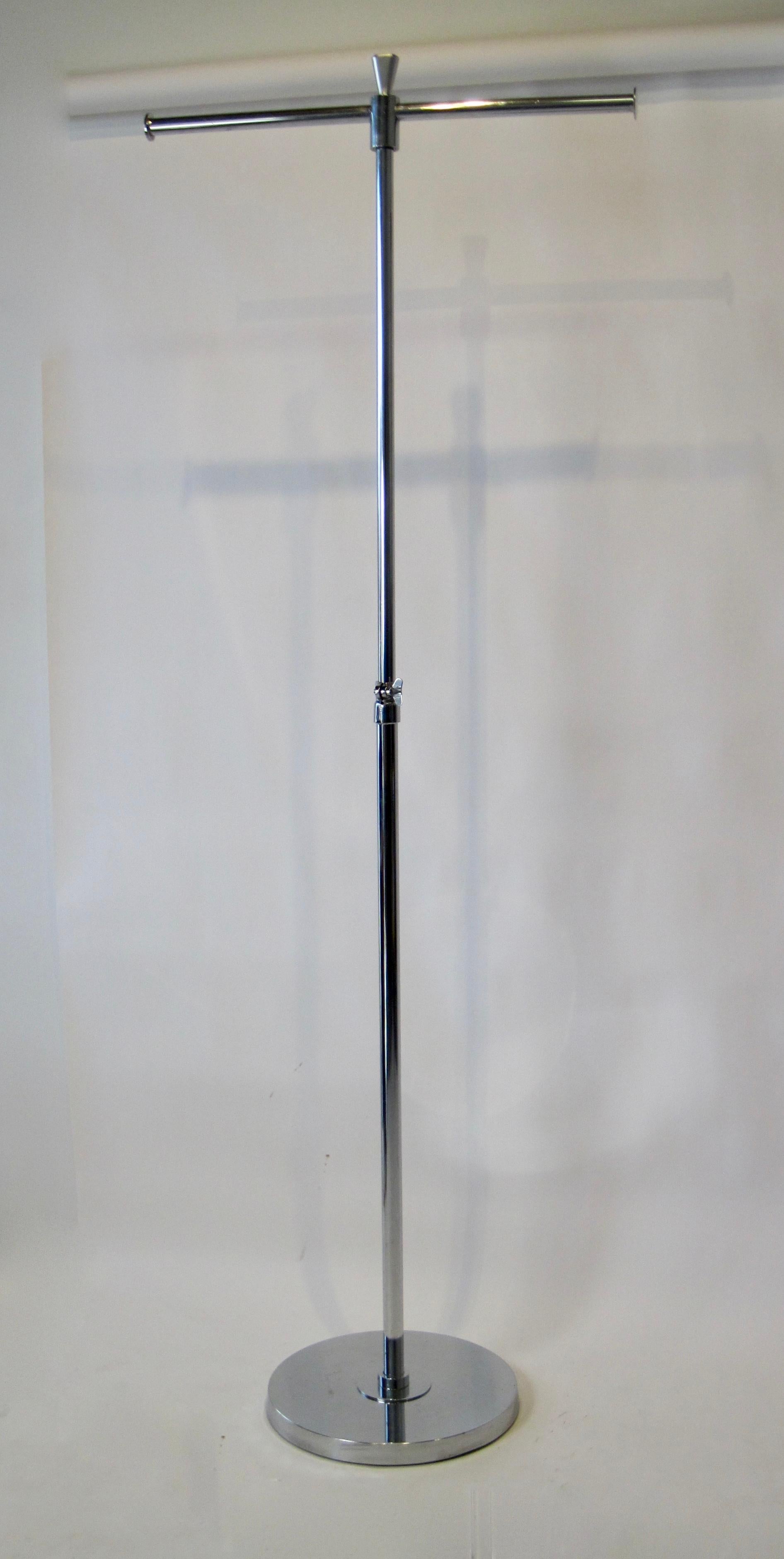 A 1940s chrome plated adjustable t-bar clothing rack stand with cast iron base. Height can be as tall as 76