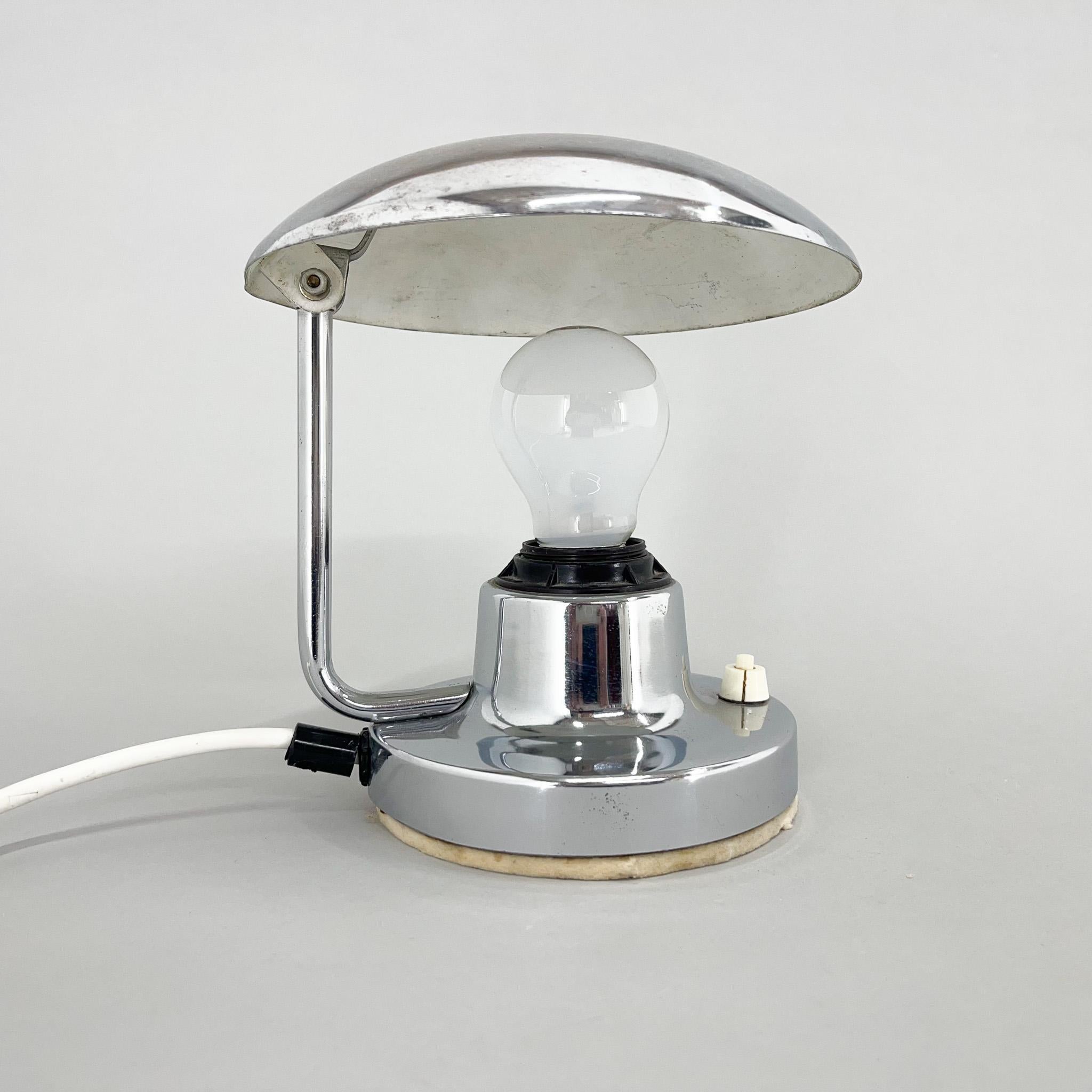 Chrome table lamp with adjustable shade made by famous Napako in 1940s. The lamp shows the wear and tear of time (see photo).