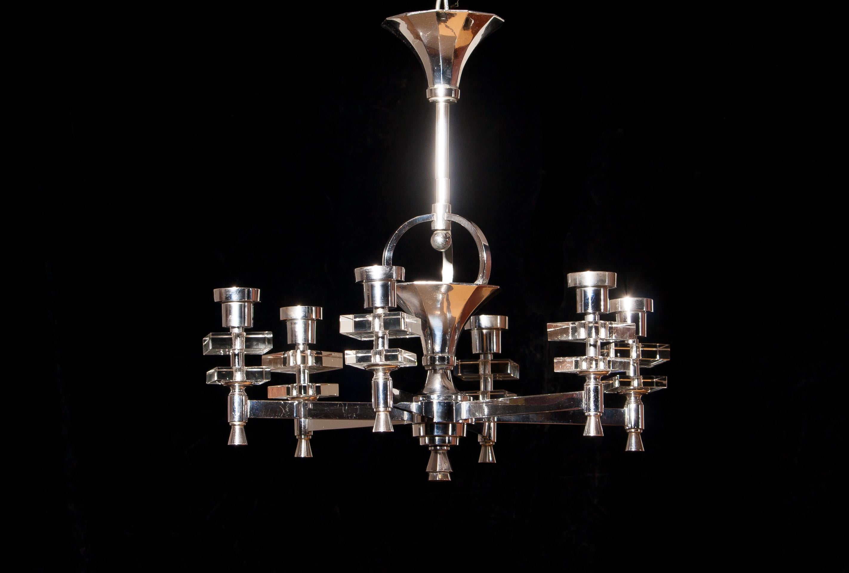 Beautiful chromed chandelier made in France.
This lamp has six arms with crystal square details.
It is in wonderful condition. (It will be totally rewired)
Period 1940s.
Dimensions: H.55 cm, ø.55 cm.