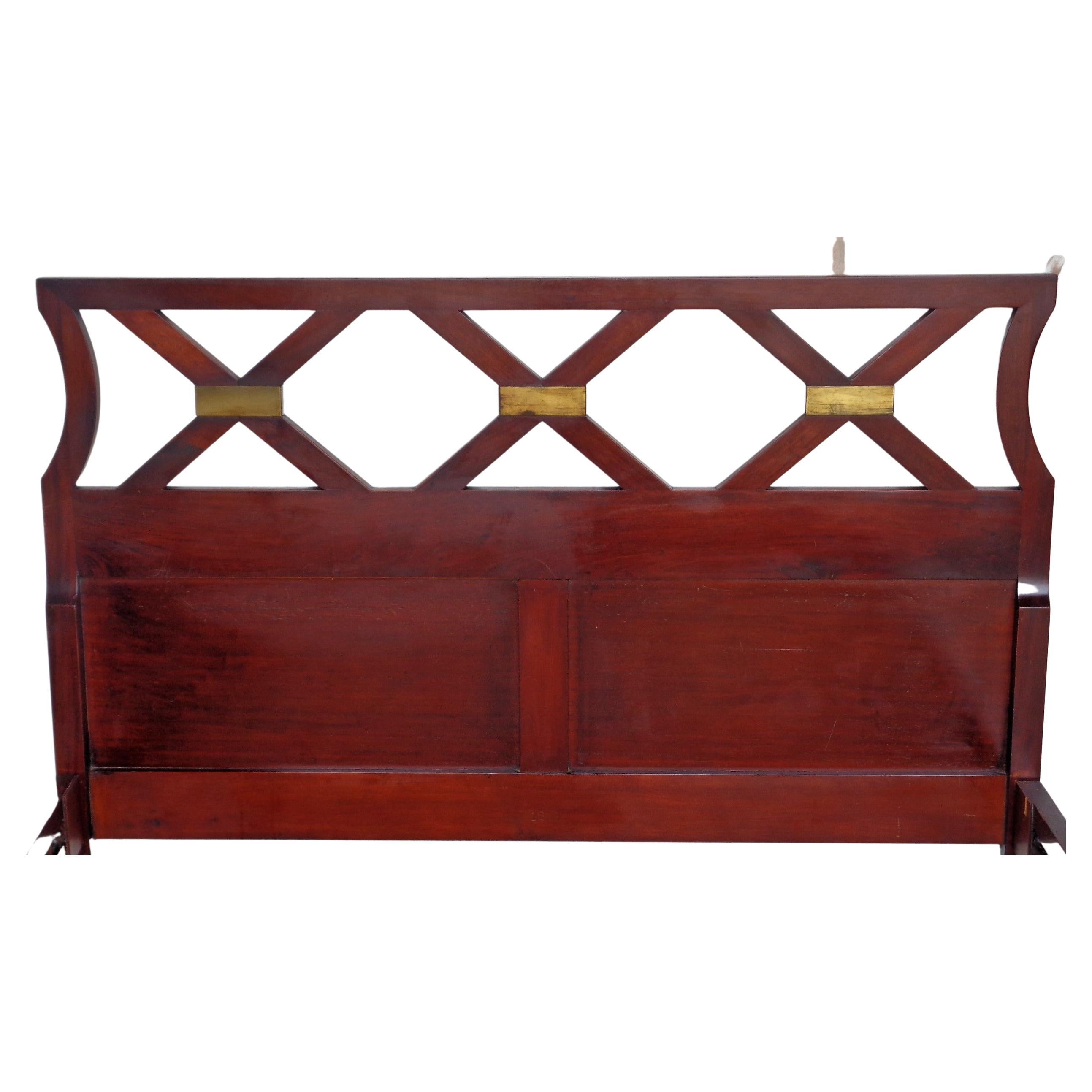 1940's High style mahogany bed by Grosfeld House. Triple X forms with lacquered brass mounts at upper part of headboard. Very elegant classical design in the manner of Tommi Parzinger. Direct from the estate of original owners. Measurements - 40