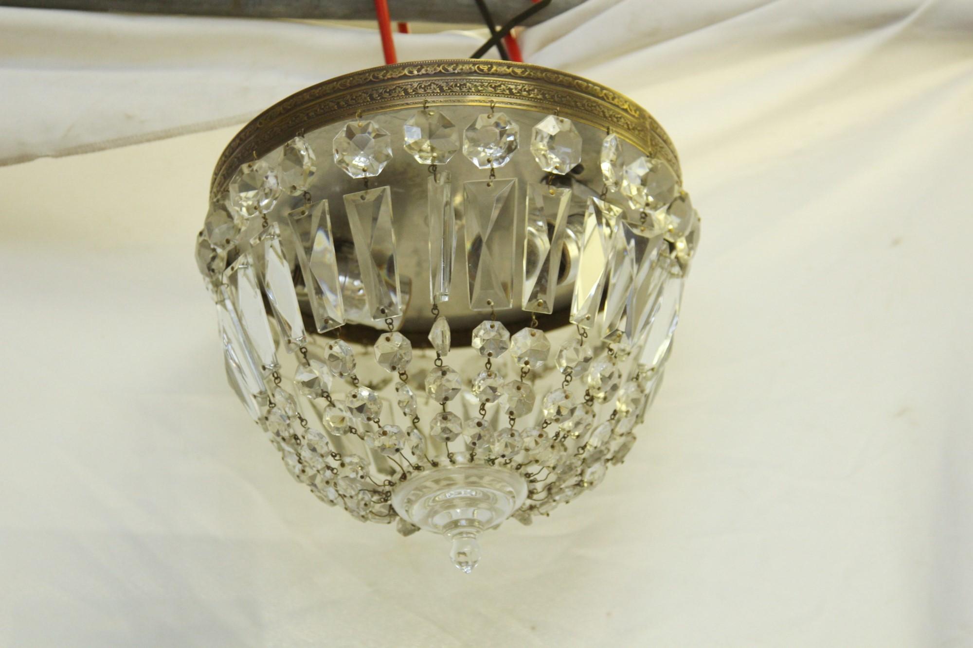 Flush mount light with an ornate bronze rim and clear crystals, circa 1940. Price includes restoration. This can be seen at our 400 Gilligan St location in Scranton. PA.