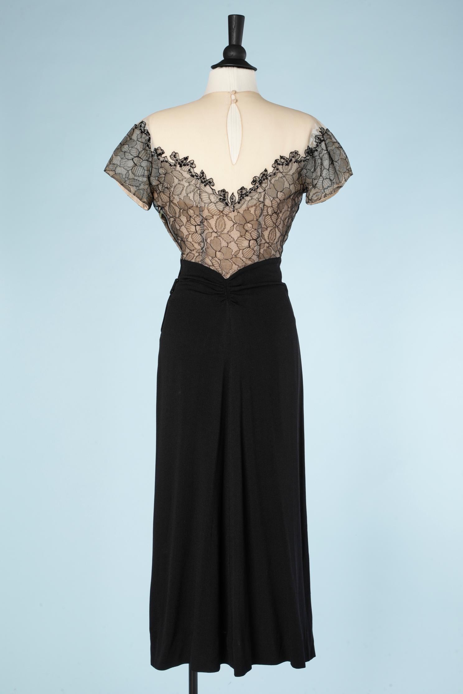 1940's cocktail dress in black crêpe and black lace appliqué on a tulle base  1