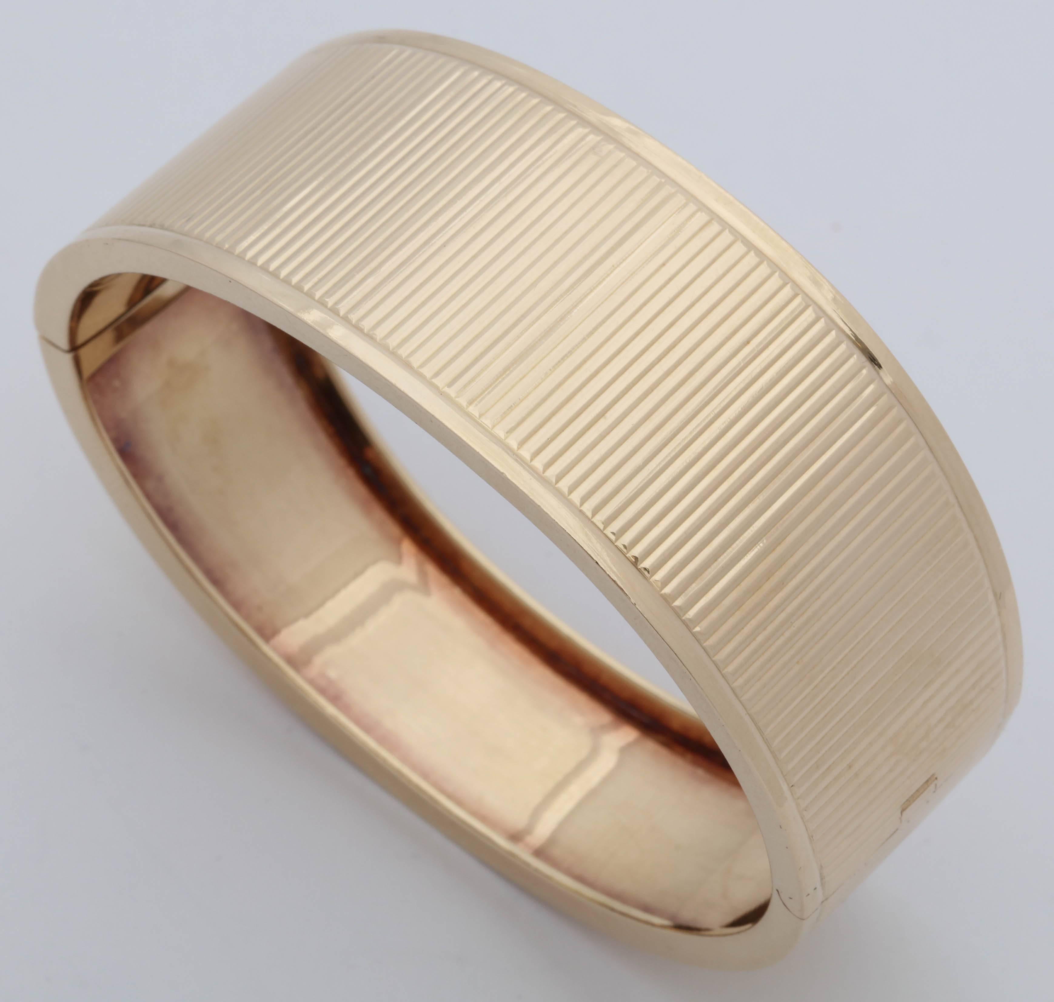 One 14kt Yellow Gold Bangle Bracelet Circa 1940's  Designed With Numerous Ridged Gold Reflective Lines And Beautifully Bordered With Two High Polish Strips Around The Edges Of The Bracelet. Side Note : These Bracelets Were Made To Be Worn Alone Or