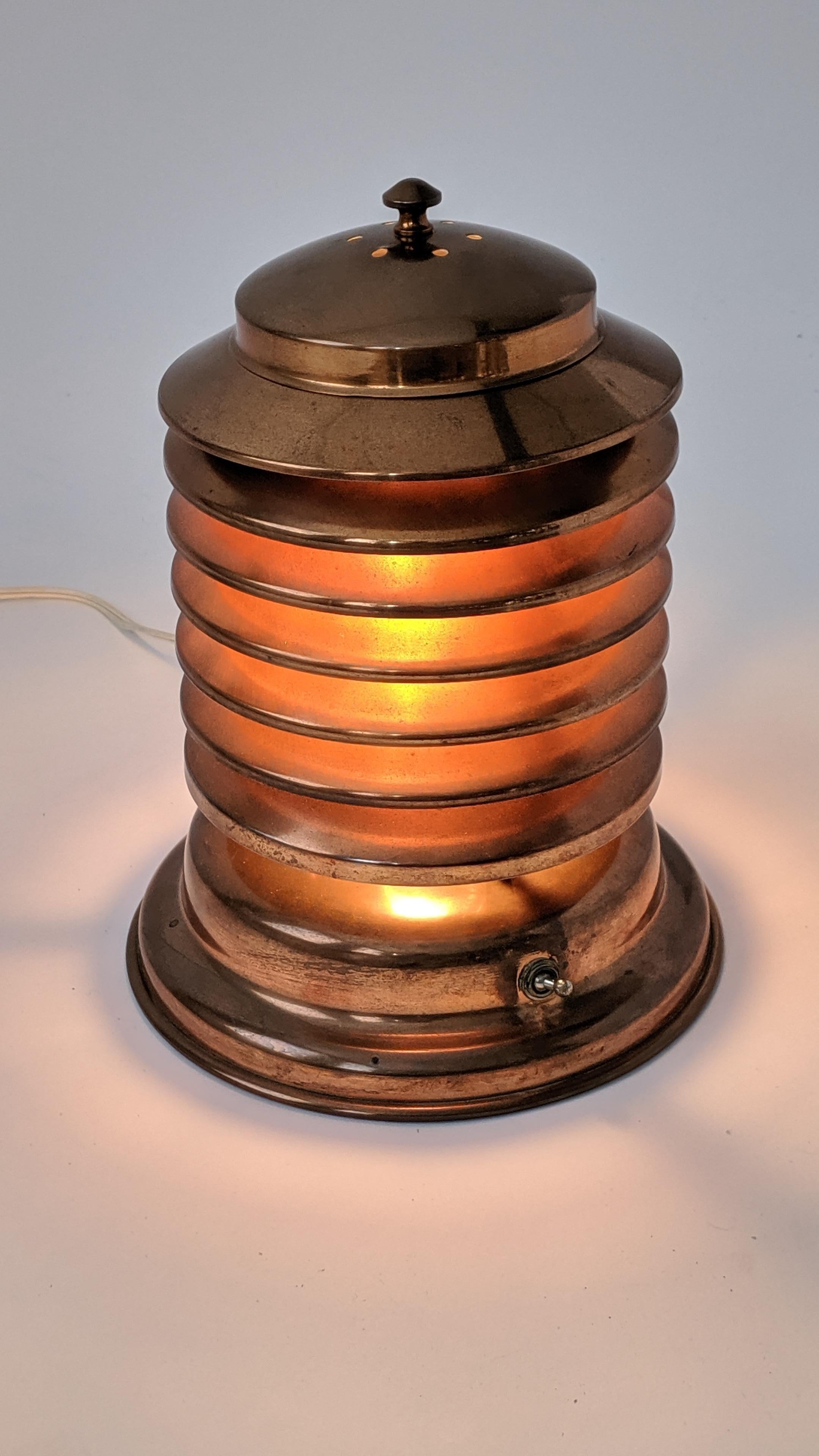 Iconic Art Deco, Machine Age Coulter seven tier copper lamp. 

Vented copper lid permit access to light bulb. 

Chrome togle switch on base. 

Contain one E26 size socket rated at 60 watt. 

Signature sticker under.