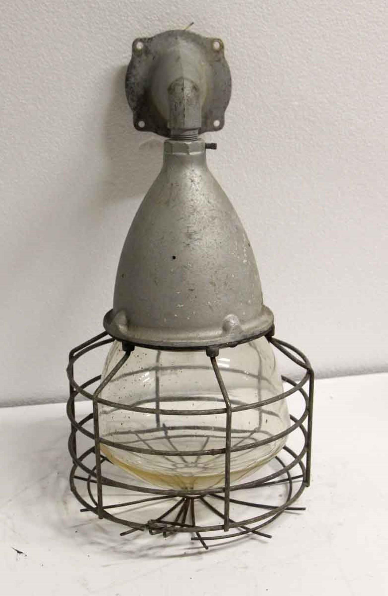 1940s industrial or nautical style cage light glass sconce with the original glass glob. Made by Crouse Hinds. Price includes rewiring. This can be seen at our 400 Gilligan St location in Scranton. PA.