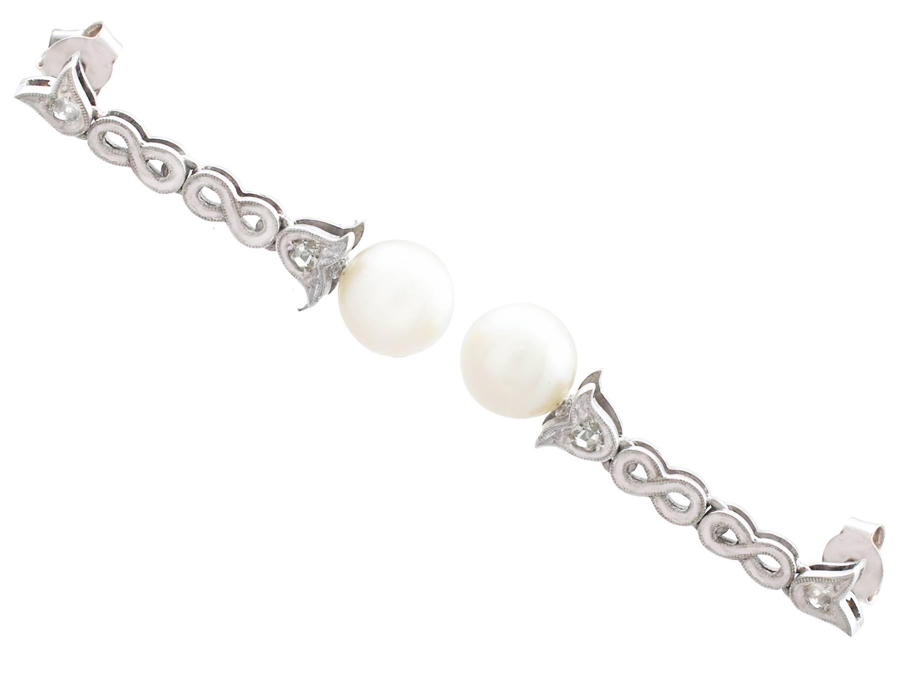 An impressive pair of cultured pearl and 0.10 carat diamond, 14 karat white gold drop earrings; part of our diverse pearl jewellery and estate jewelry collections.

These fine and impressive pearl drop earrings have been crafted in 14k white