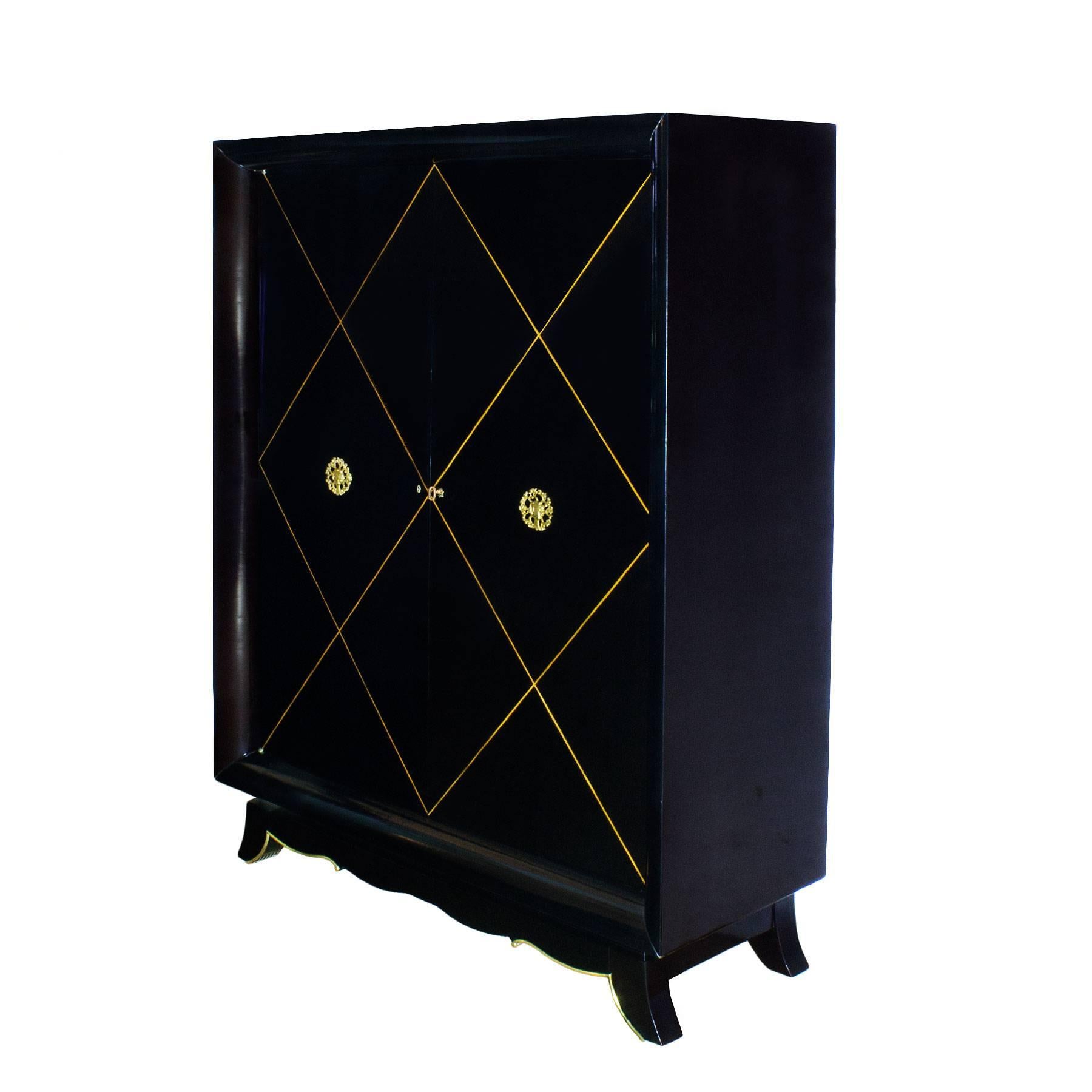 Nice cupboard, stained maple with sycamore geometrical marquetry on doors, french polish. Two lovely golden bronze decorations representing spring and summer. Polished brass strips on base. Three shelves inside, adjustable height. Can be completely