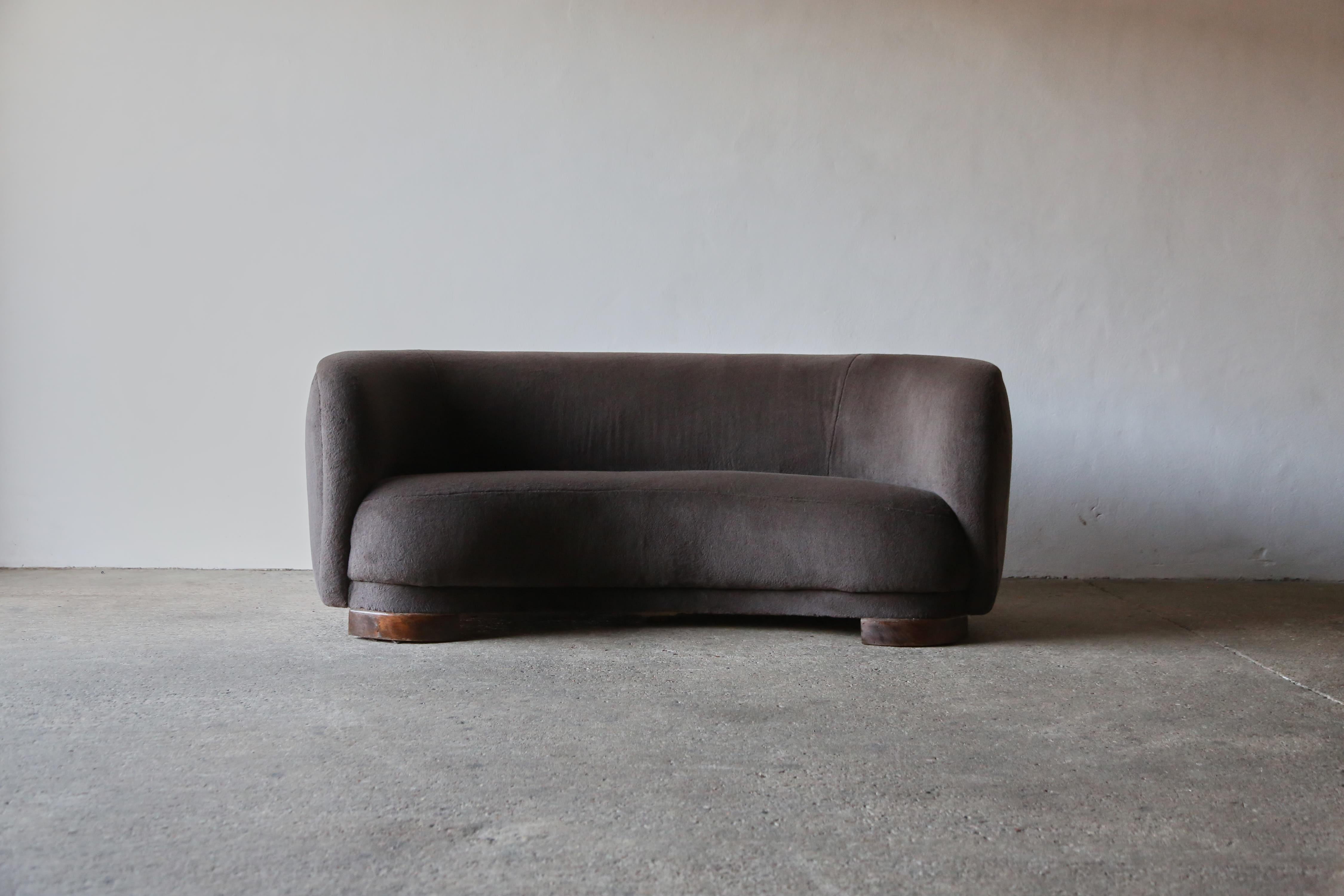 A superb curved 1940s Danish sofa, newly upholstered in a premium, brown/grey, 100% Alpaca fabric. Ships worldwide.






