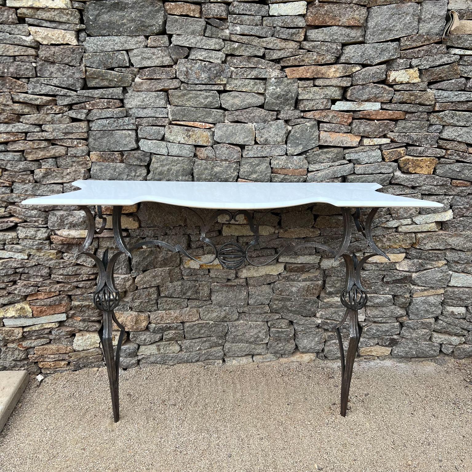 1940s Vintage Custom Italian Wrought iron marble console table 
Design style after Gilbert Poillerat
Shows Poillerat type stylized hand forged wrought iron base
Unmarked
Features new marble stone top, custom design with beveled edge.
Console