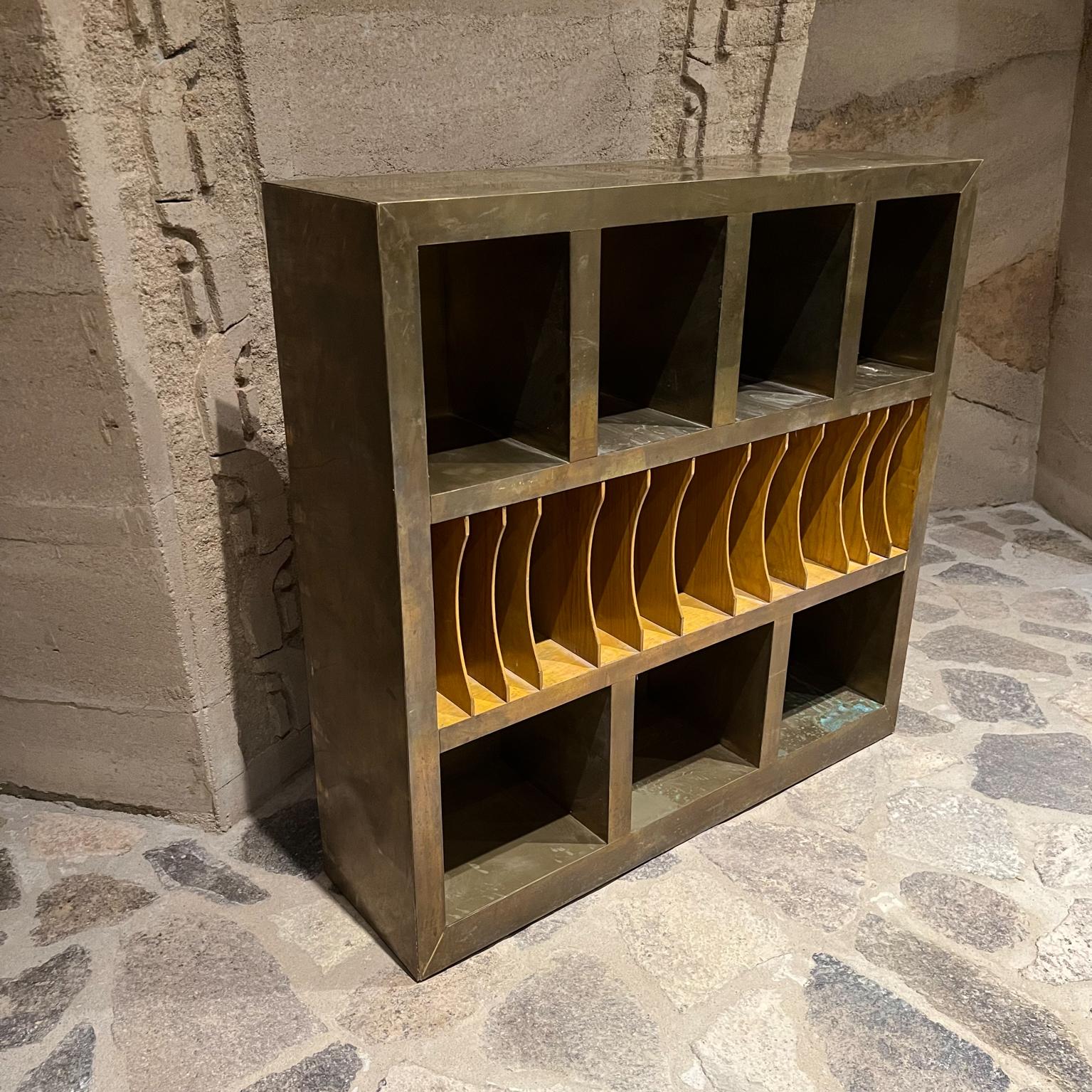 Custom Vintage Sectioned Storage Bookcase 
Wood Wrapped in Brass
Fabulous open organizer cabinet.
Measures: 42.25 tall x 11.75 D x 43 W.
Upper storage 8.25 W x 11.5 D x 11.5 tall Middle 2 W x 11.5 D x 11.5 d bottom 11.78 x 11.5d x 11.5