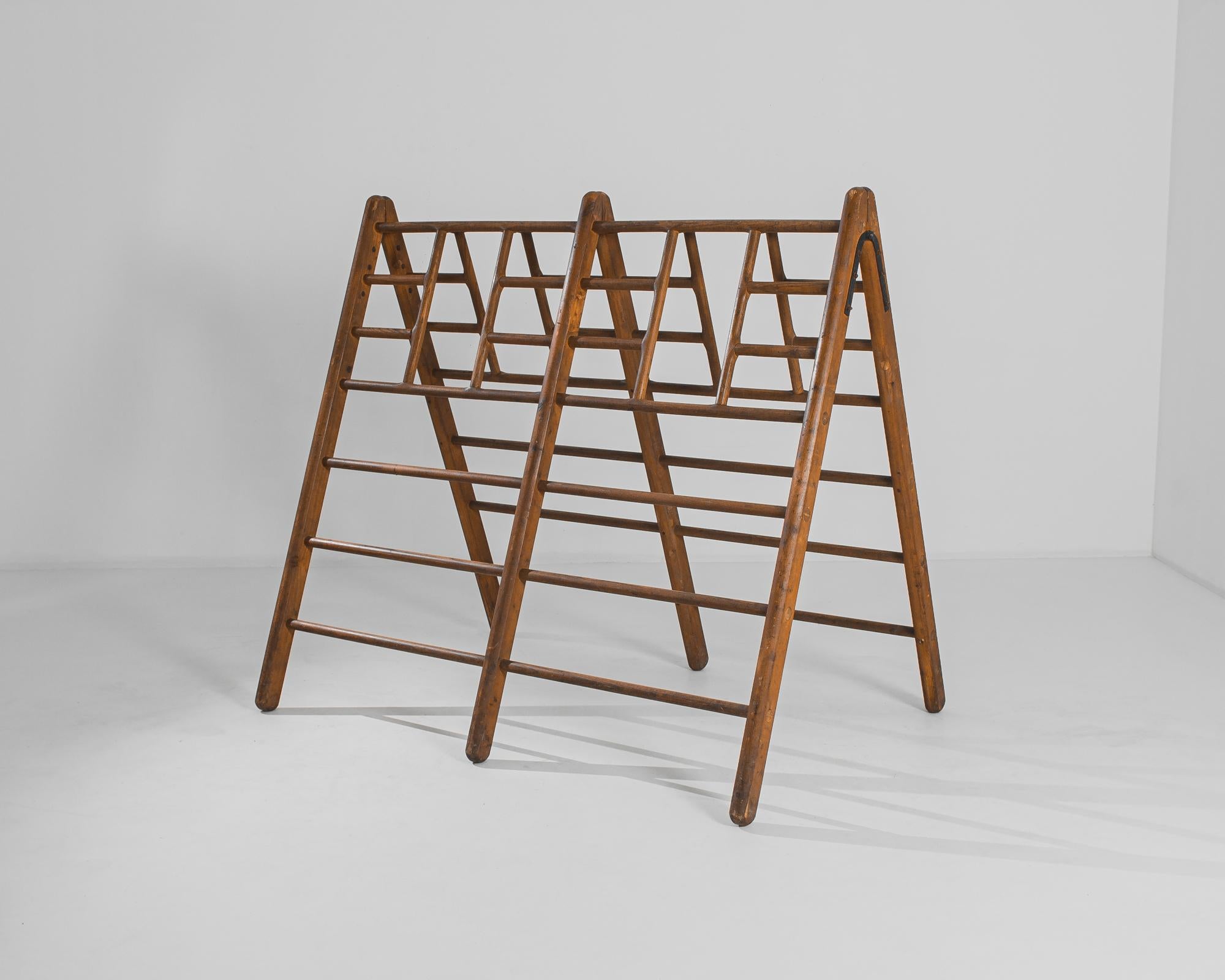 This wooden children's gym was made in the former Czechoslovakia, circa 1940. Featuring a geometric silhouette with gridded bars, the A-framed structure can be adapted for a plethora of uses, from a rack to a sculptural display piece. With its