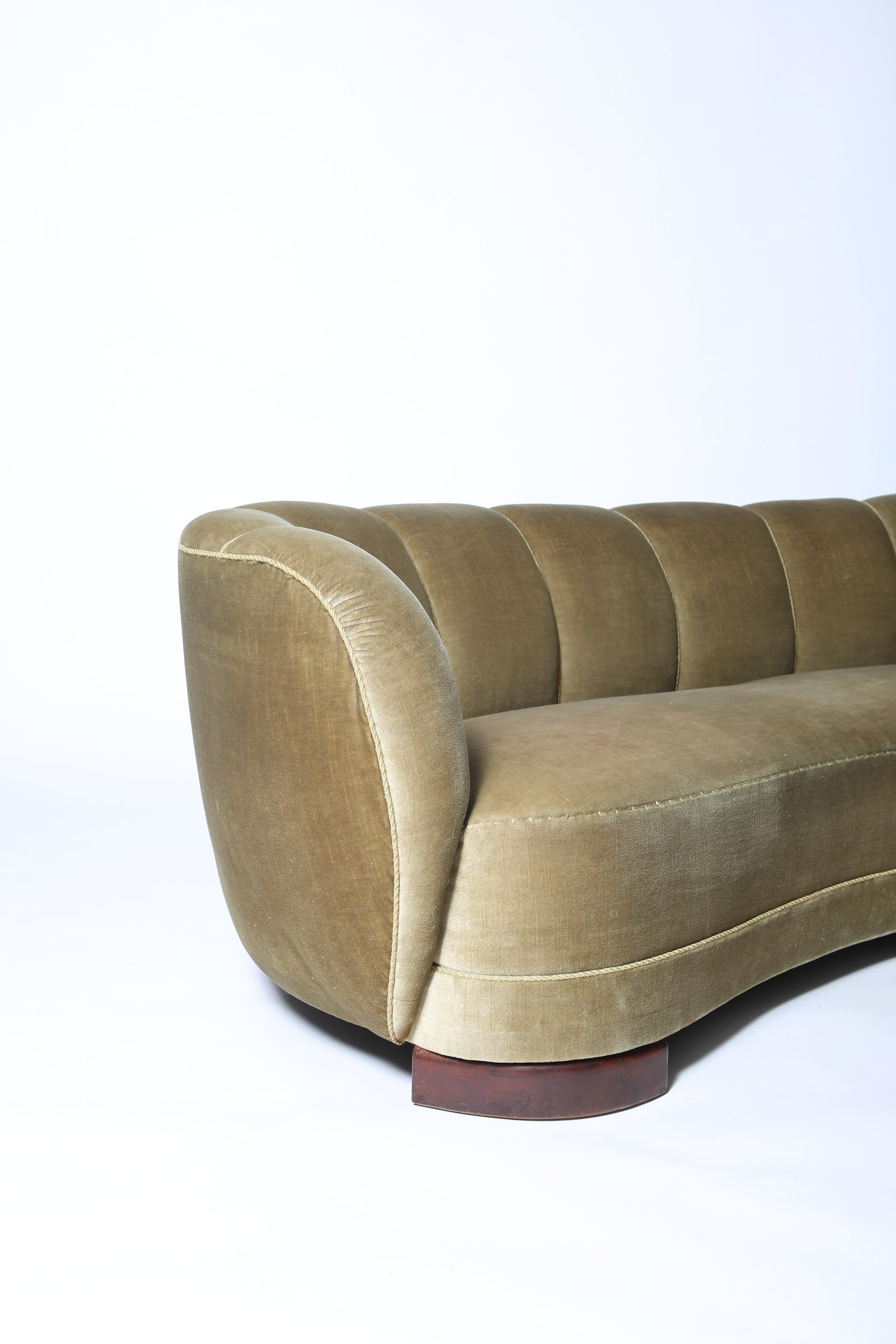 Danish Cabinetmaker-made classic curved “banana” sofa with original pale green mohair upholstery. Tailored channel-back is low-profile and elegantly curved with softly-rounded arms. Stained beech feet. Imported from Denmark. Very good condition.